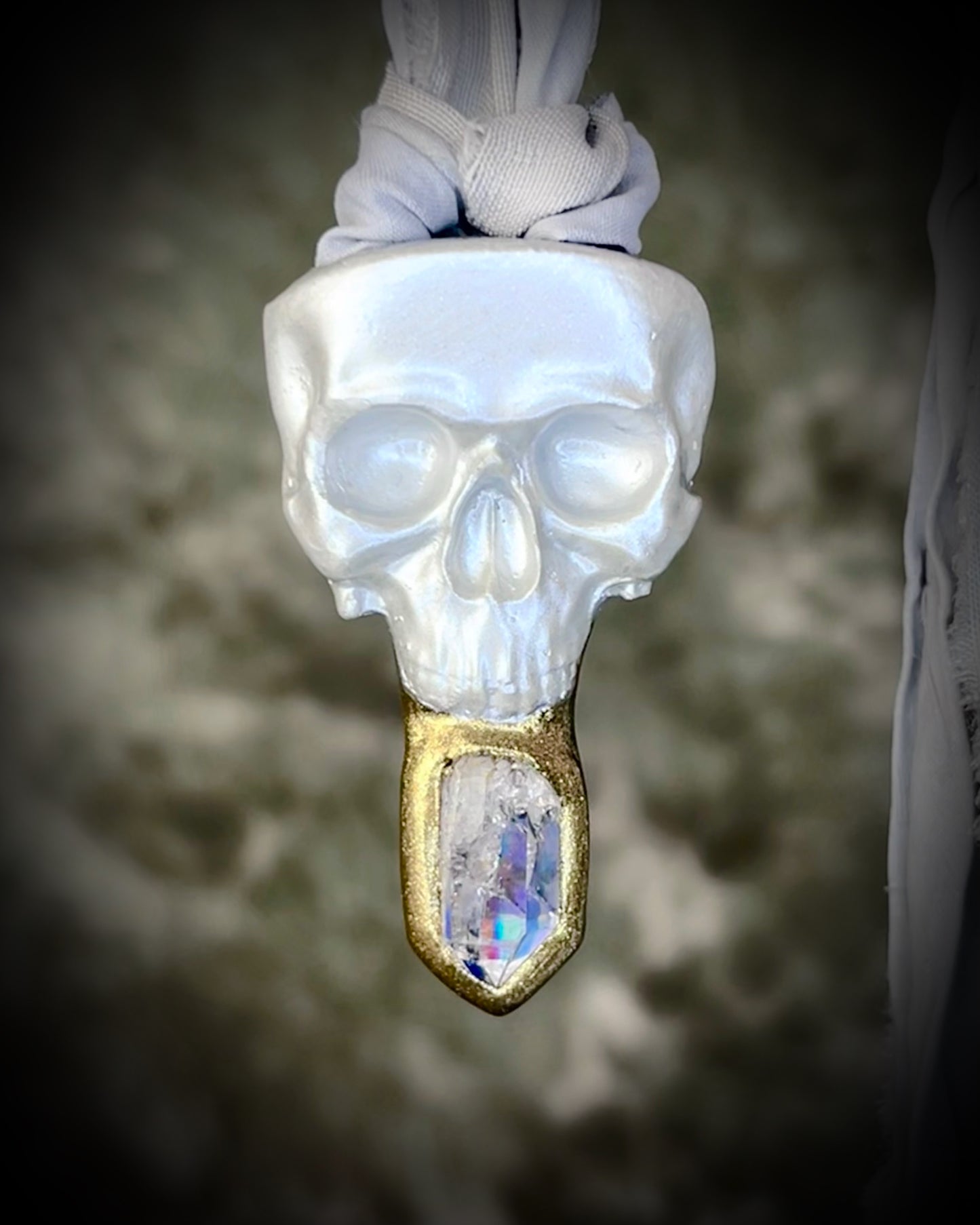 White pearl Skull-shaped pendant with a gold base and clear rainbow crystal on grey recycled silk.  White witch 2025 fall necklace gift for her. 