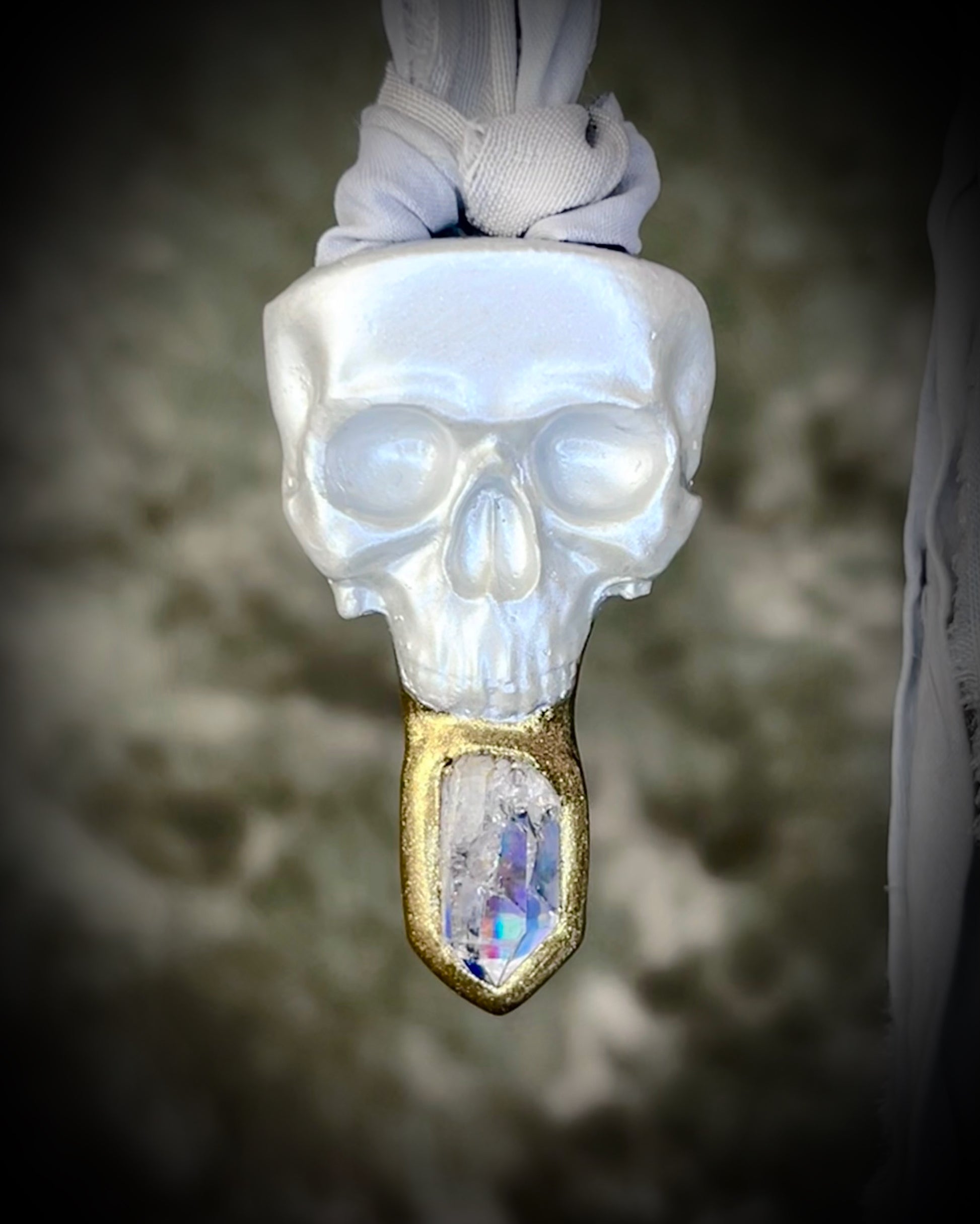 White pearl Skull-shaped pendant with a gold base and clear rainbow crystal on grey recycled silk.  White witch 2025 fall necklace gift for her. 