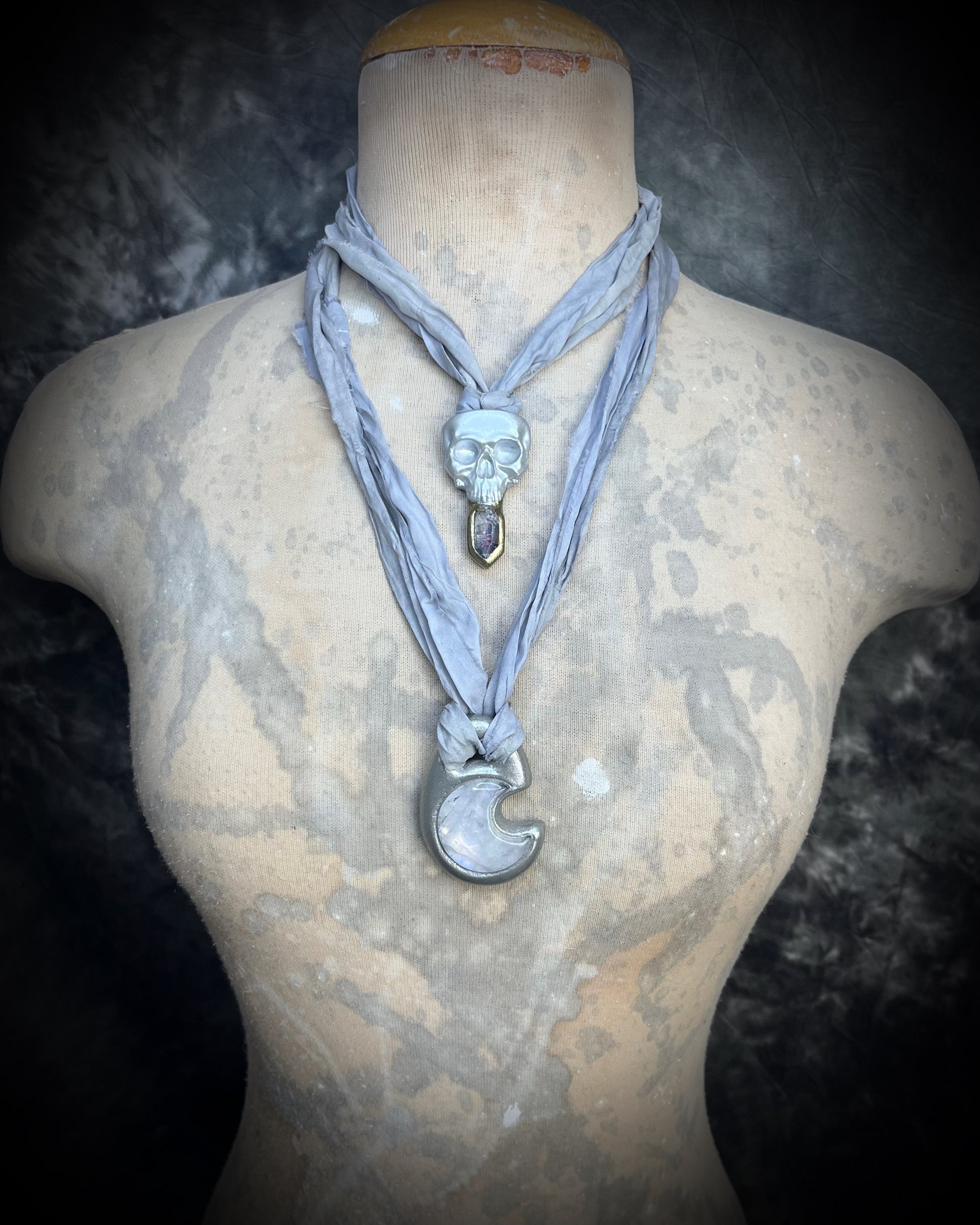 White pearl Skull-shaped pendant with a gold base and clear rainbow crystal on grey recycled silk.  White witch 2025 fall necklace gift for her. 