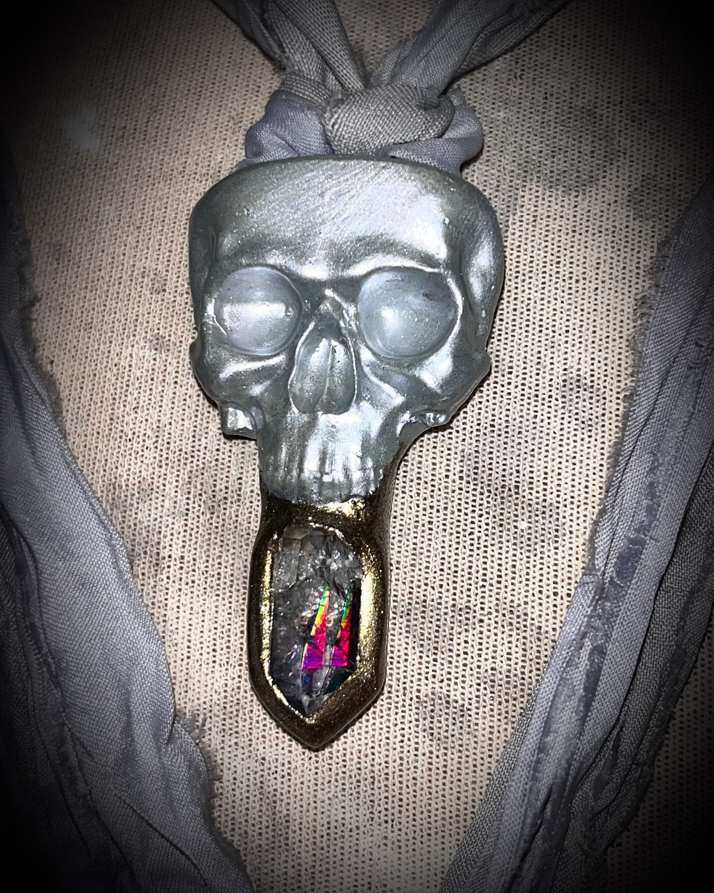 White pearl Skull-shaped pendant with a gold base and clear rainbow crystal on grey recycled silk.  White witch 2025 fall necklace gift for her. 