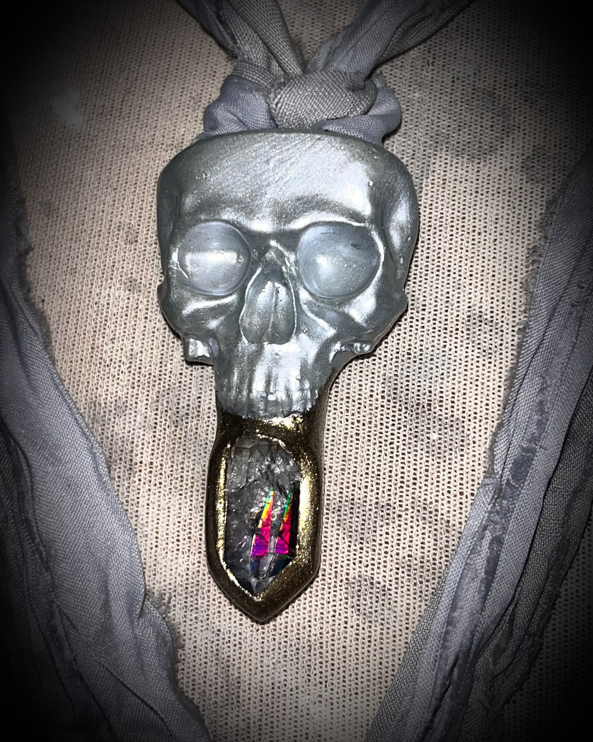 White pearl Skull-shaped pendant with a gold base and clear rainbow crystal on grey recycled silk.  White witch 2025 fall necklace gift for her. 