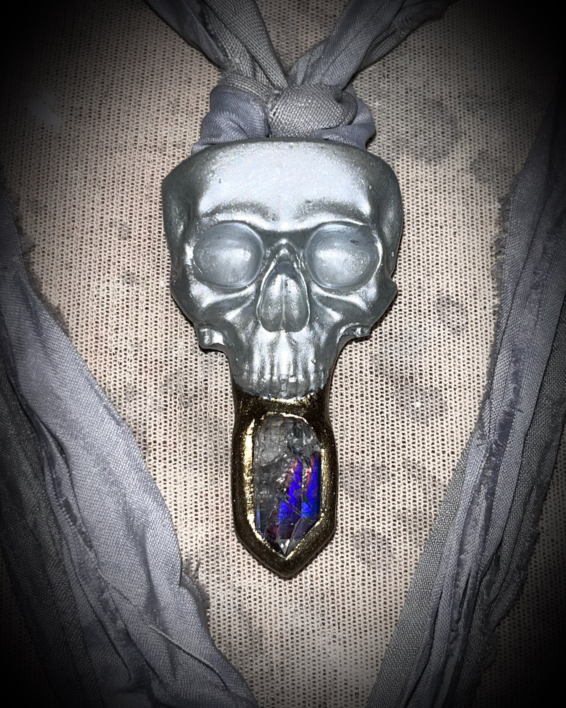 White pearl Skull-shaped pendant with a gold base and clear rainbow crystal on grey recycled silk.  White witch 2025 fall necklace gift for her. 