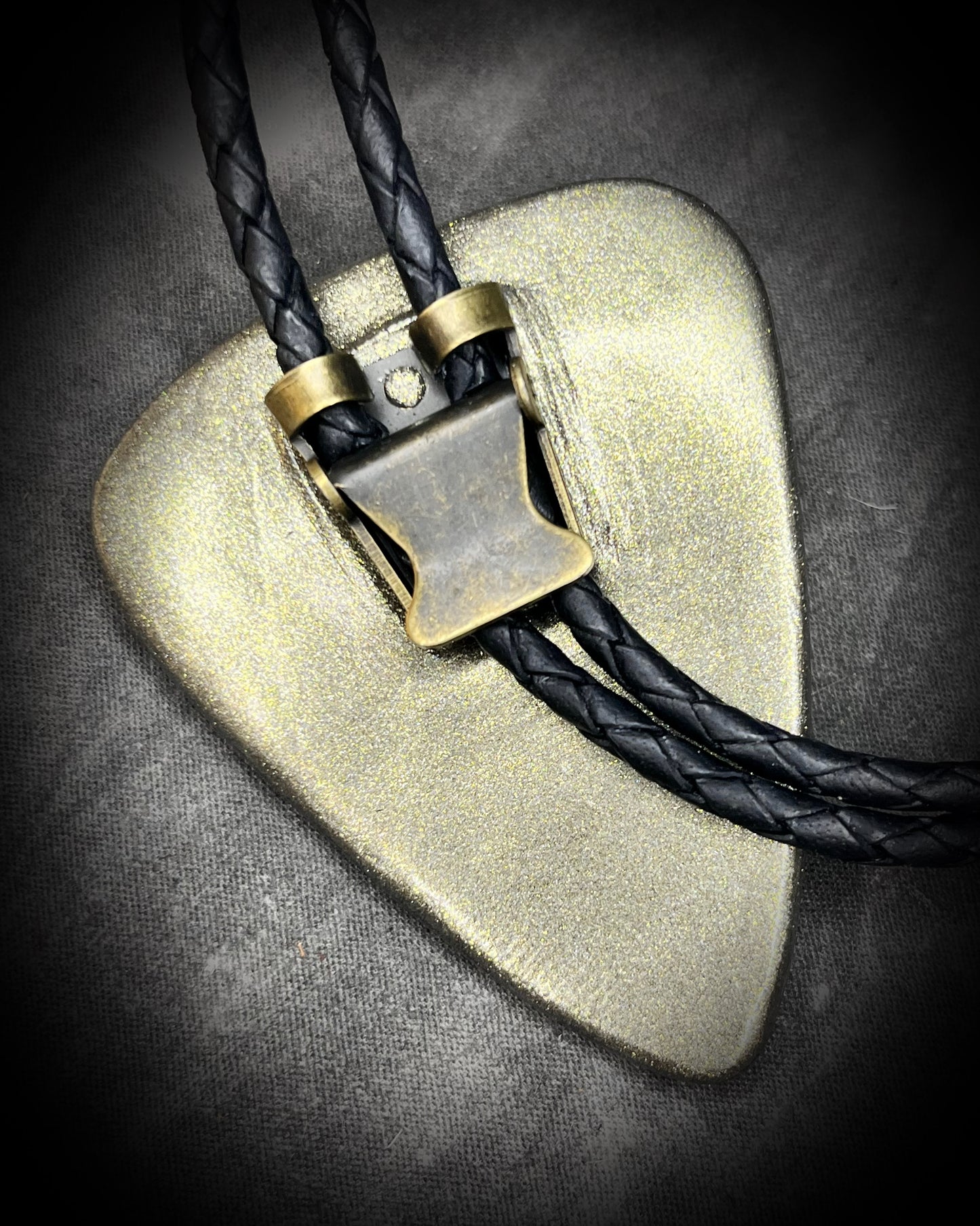 Adjustable bolo slide shown on black leather cord