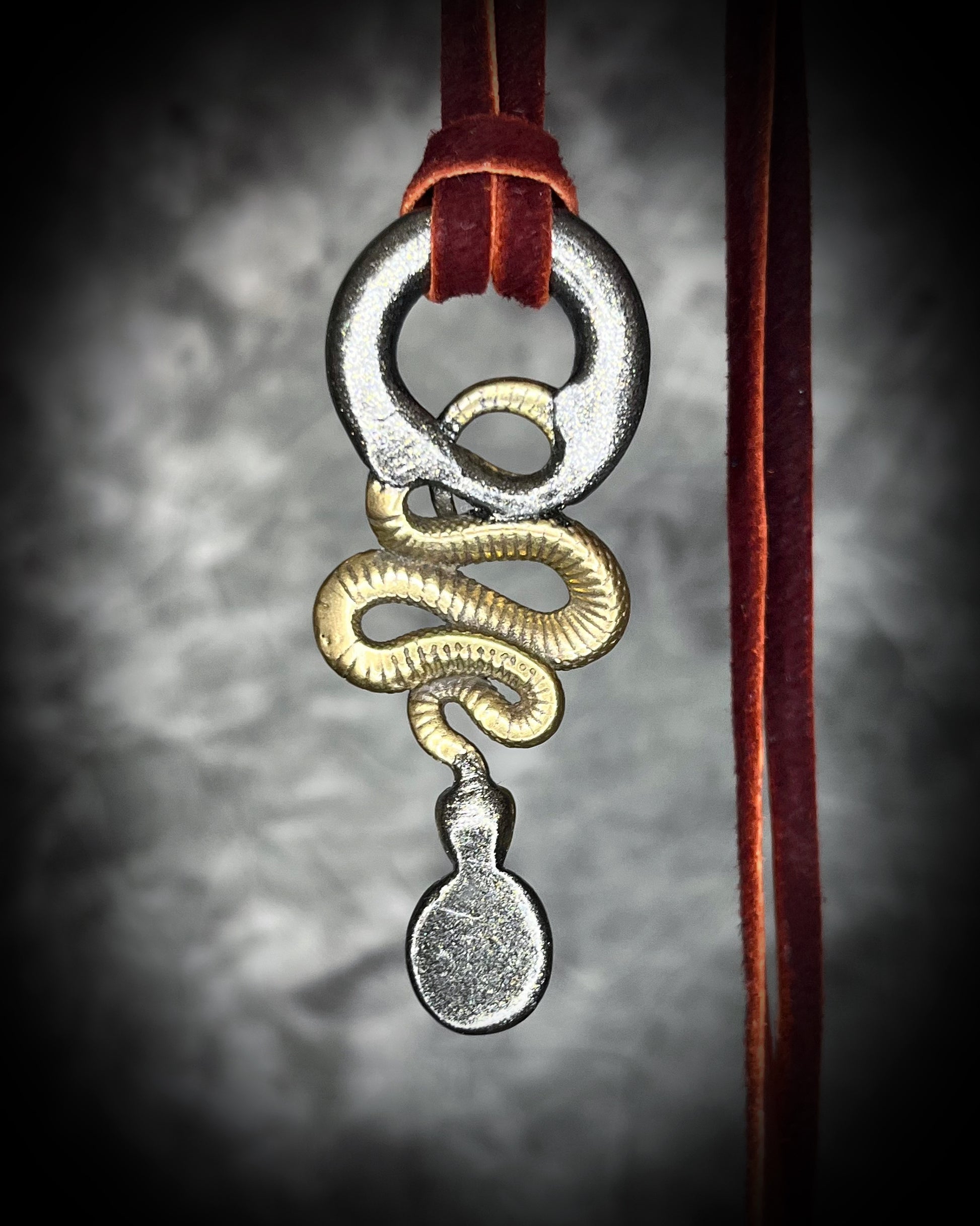Artisan black opal and brass snake necklace, gothic witch jewelry symbolizing transformation, creativity, and magical protection.