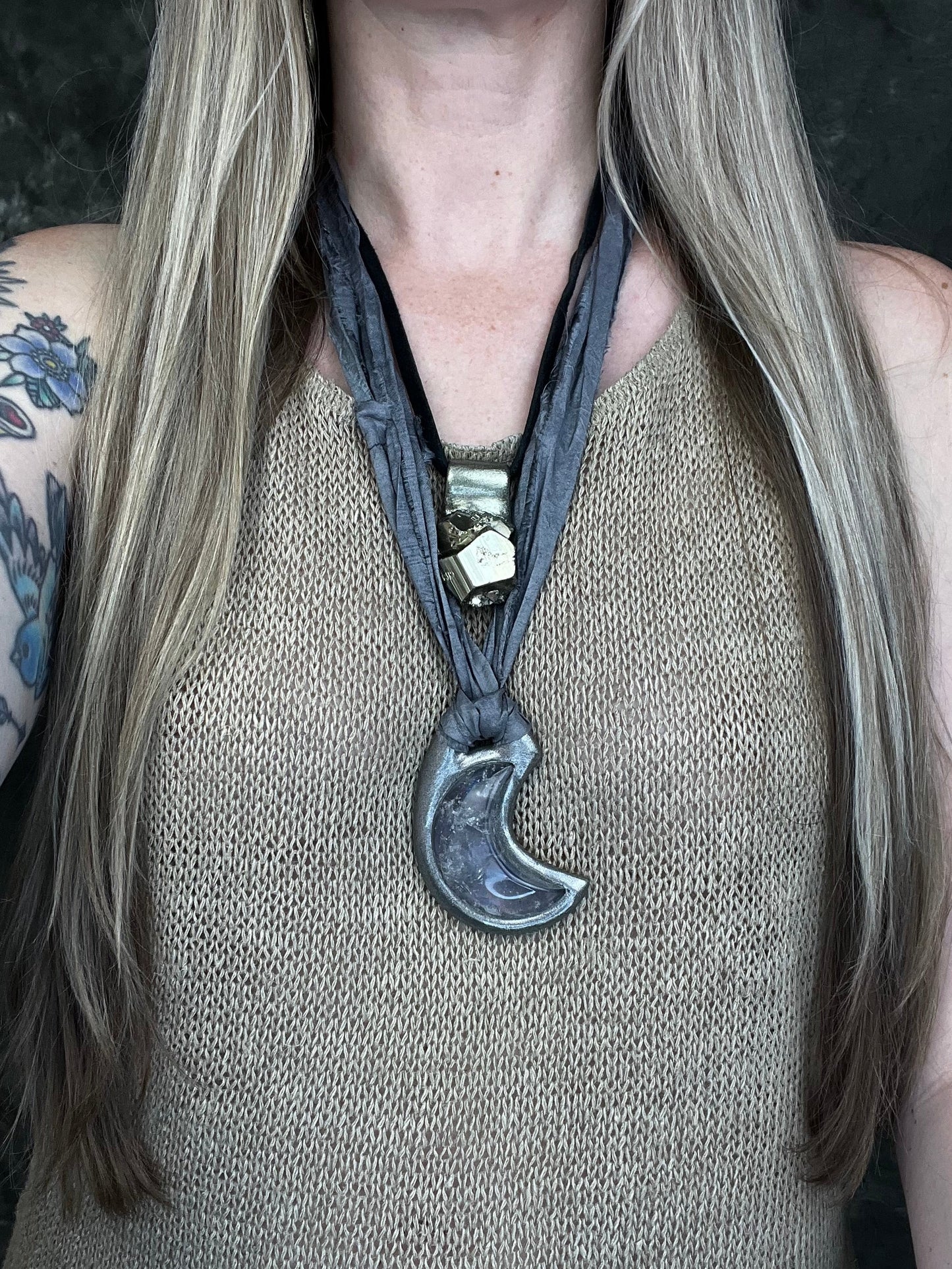 Black rainbow quartz crescent moon talisman on recycled silk with dark iridescent rainbow flashes, handcrafted by Become Spellbound.