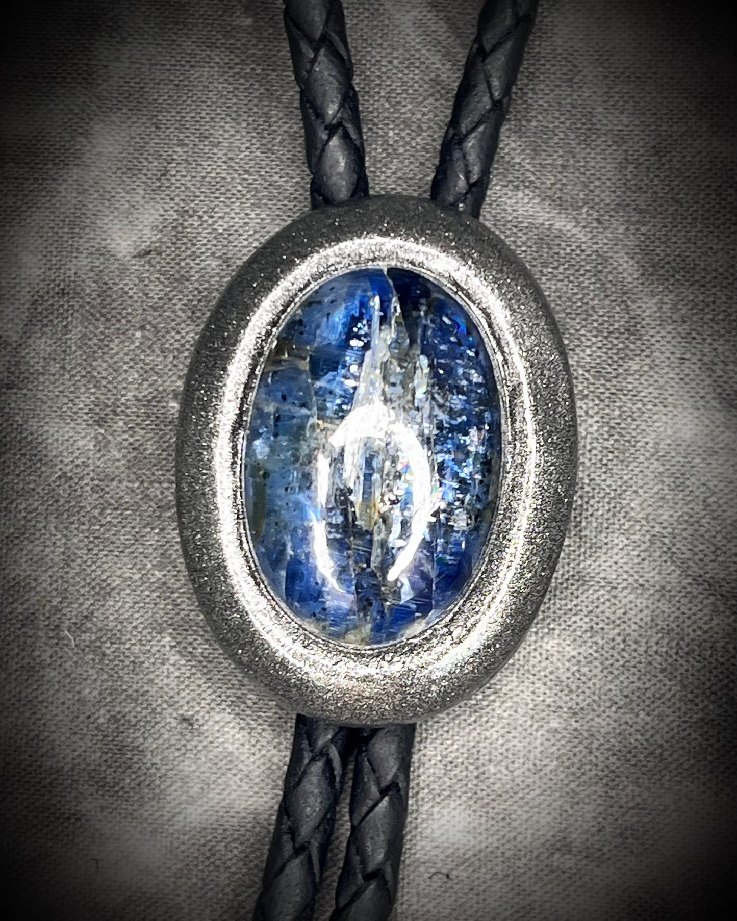 Blue kyanite handmade bolo tie for him or her, gunmetal silver finish on black leather.