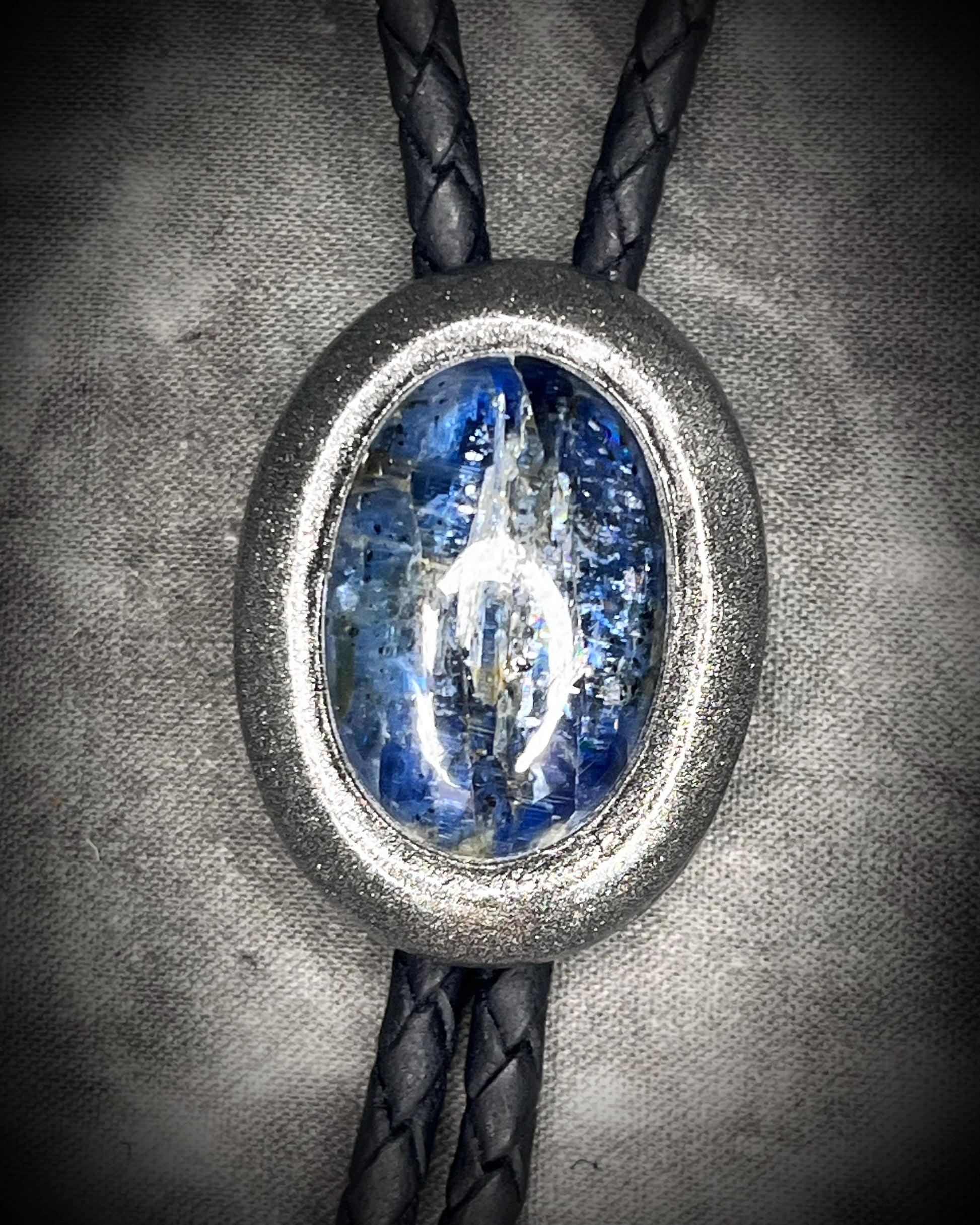 Blue kyanite handmade bolo tie for him or her, gunmetal silver finish on black leather.
