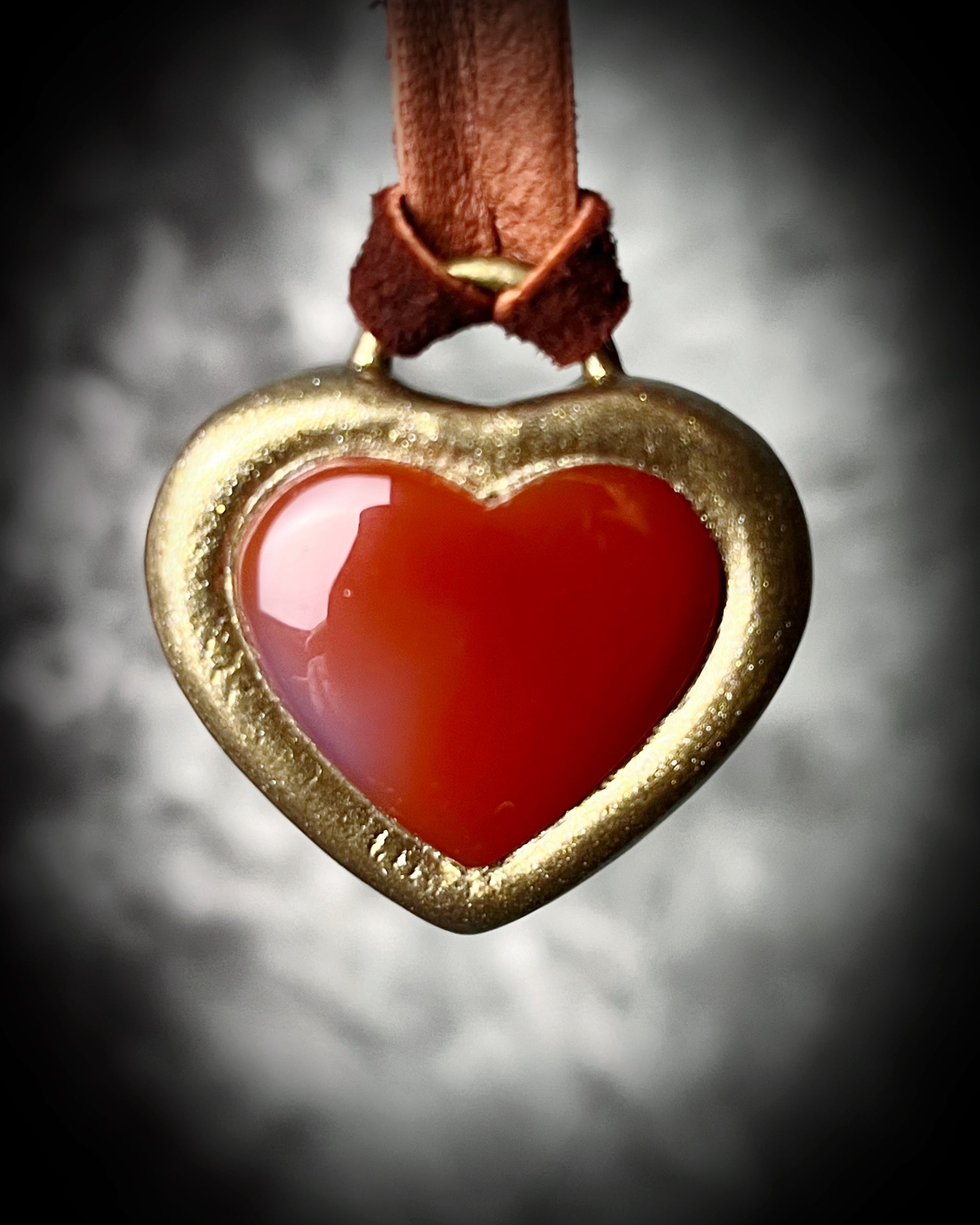 Bold Carnelian heart crystal pendant on dark brown leather cord, mystical autumn jewelry for grounding energy, strength, and warm bohemian vibes.