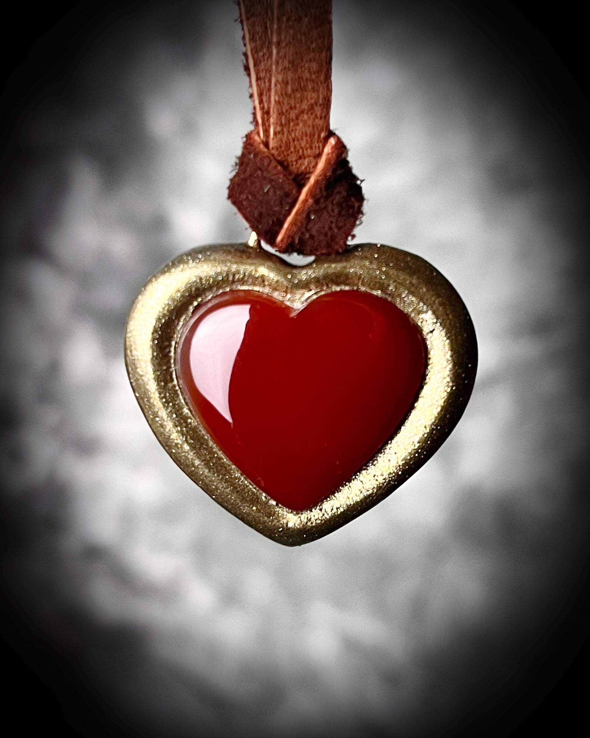 Bold Carnelian heart crystal pendant on dark brown leather cord, mystical autumn jewelry for grounding energy, strength, and warm bohemian vibes.
