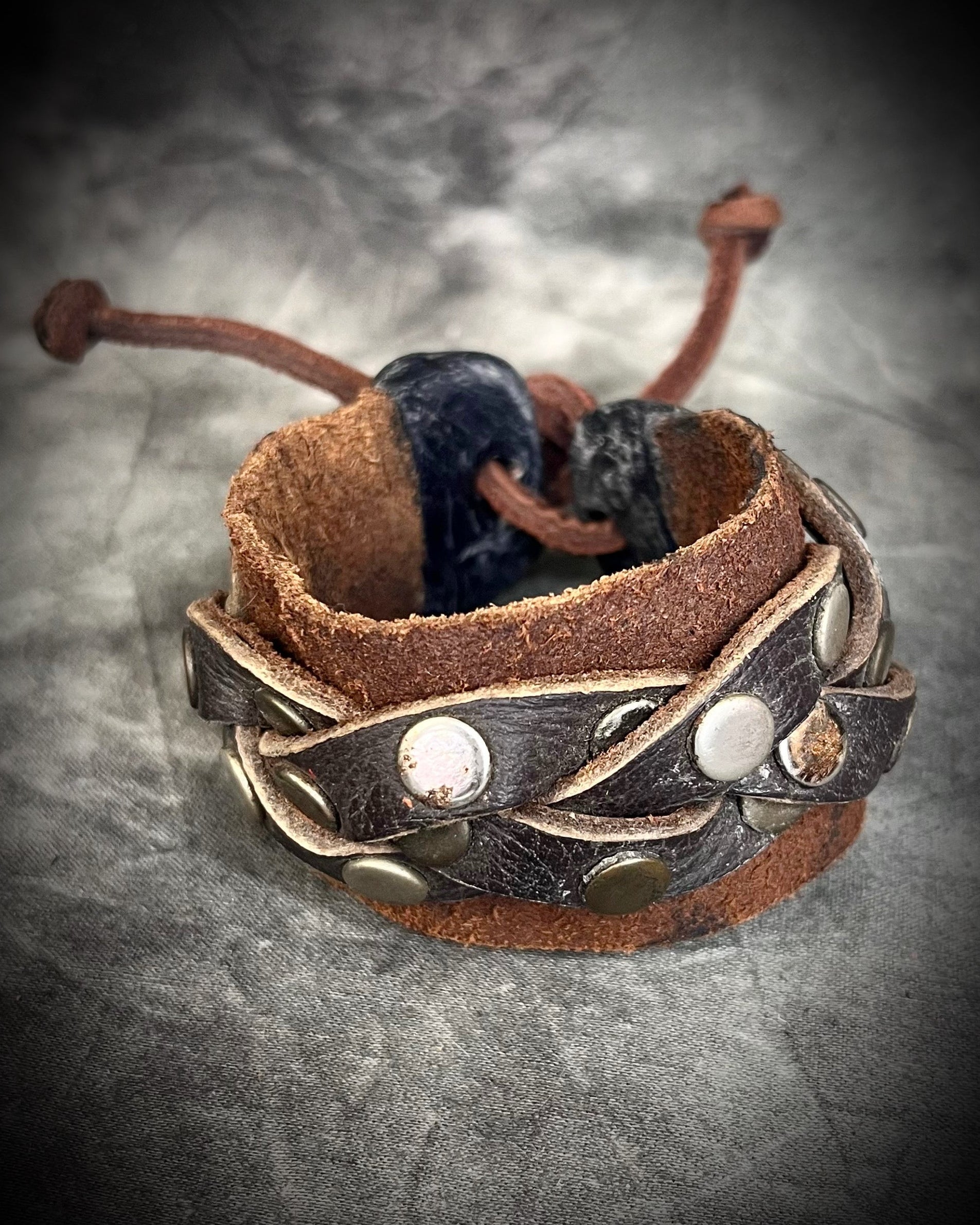 Brown braided leather bracelet with metal studs and carnelian crystal accents. Unisex crystal healing cuff jewelry gift for him or her. 