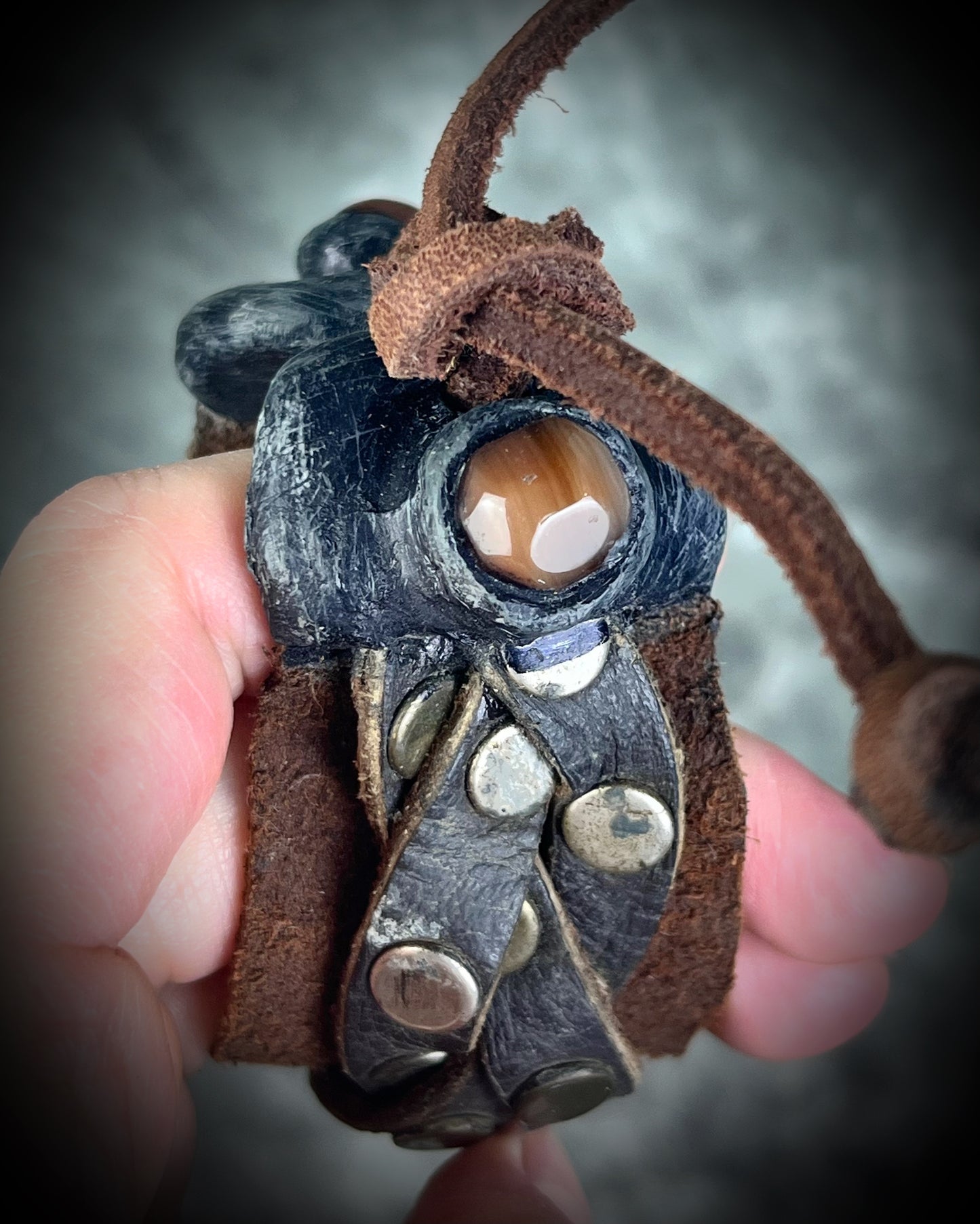 Brown braided leather bracelet with metal studs and carnelian crystal accents. Unisex crystal healing cuff jewelry gift for him or her. 