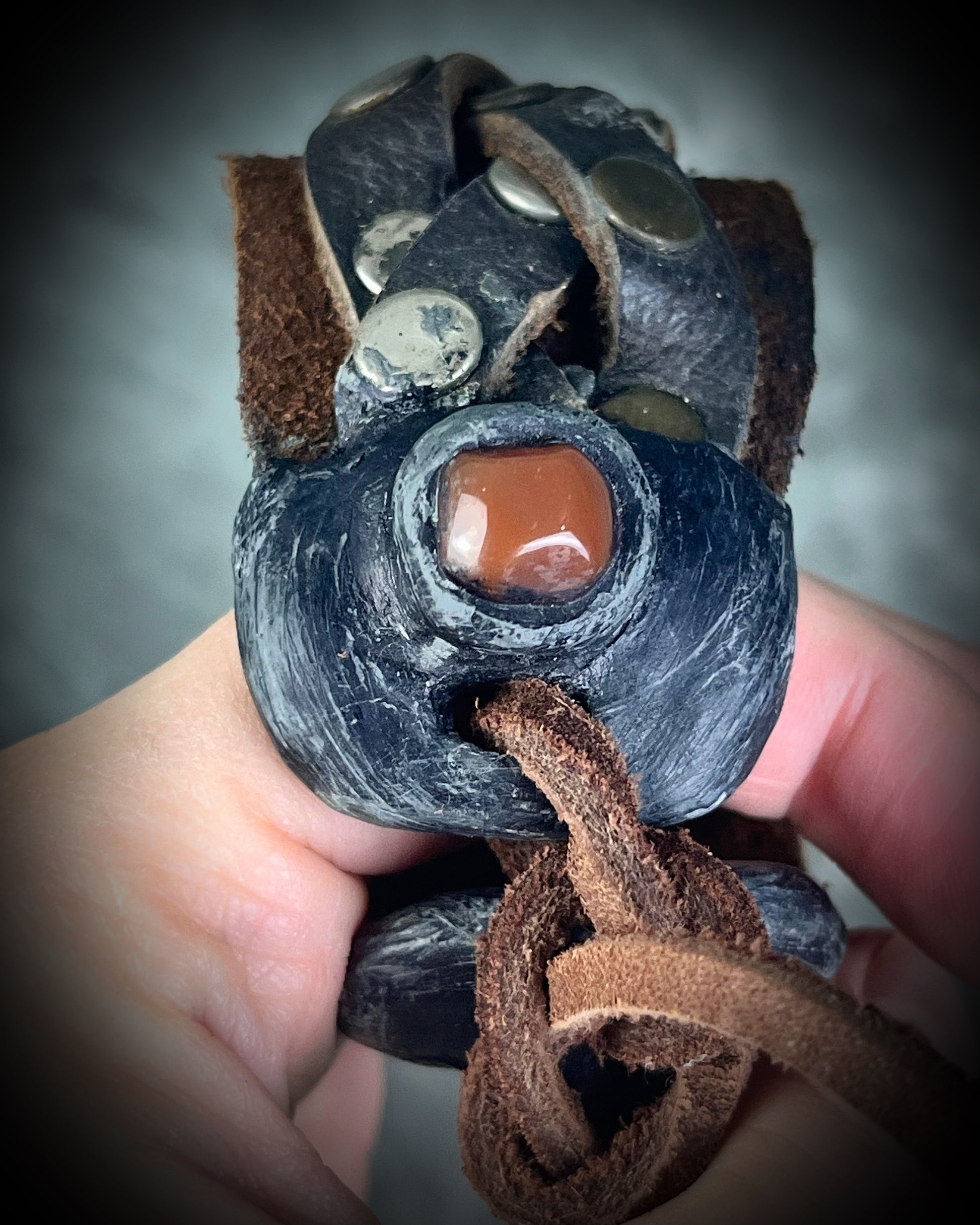 Brown braided leather bracelet with metal studs and carnelian crystal accents. Unisex crystal healing cuff jewelry gift for him or her. 