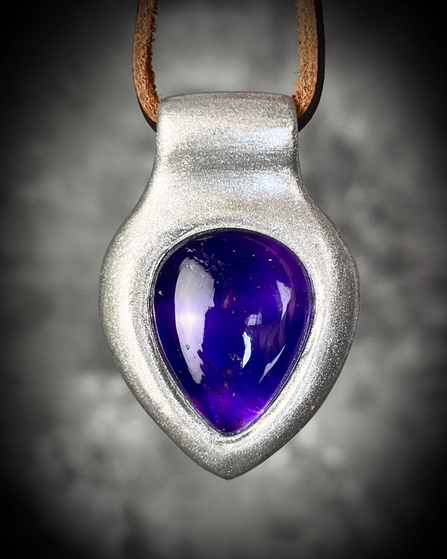Enchanting amethyst crystal teardrop silver pendant hung from soft organic brown leather. Mystical and spiritual handmade gift jewelry for her. Birthstone jewelry for her. Aquarius gift necklace. 