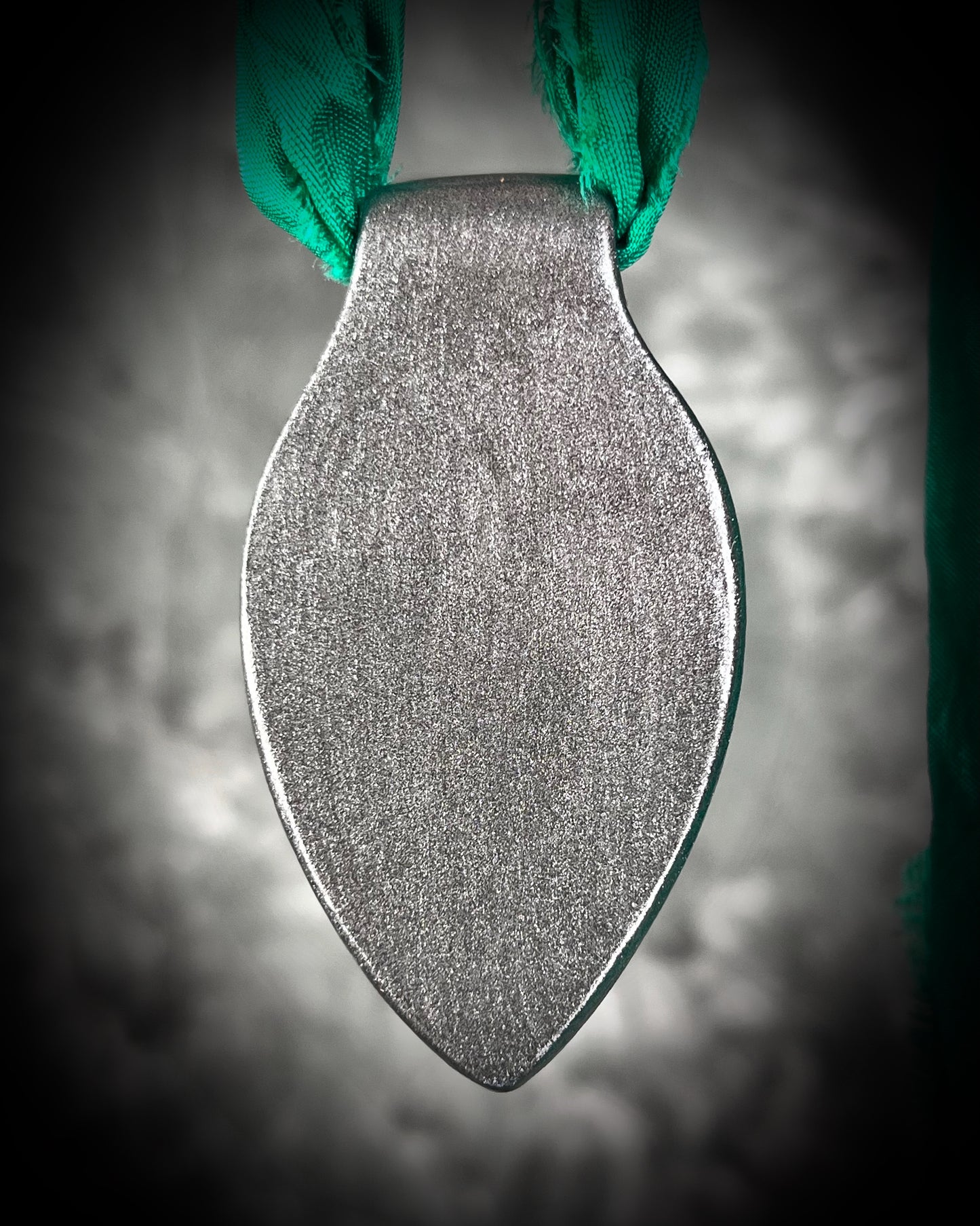 Chlorite Included Quartz necklace in a dark silver gunmetal finish on emerald green recycled silk, glowing with natural green mosslike crystal inclusions.