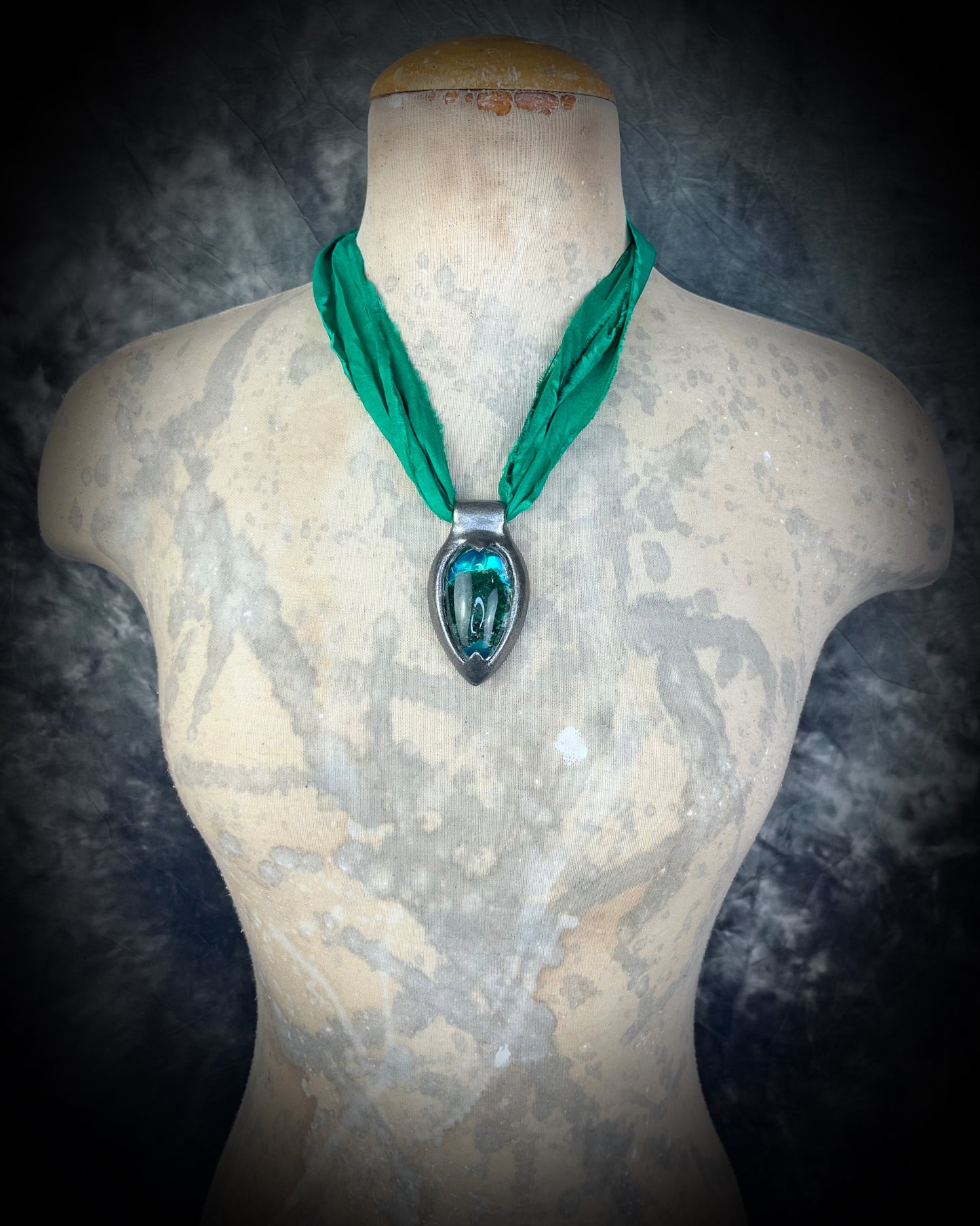 Chlorite Included Quartz necklace in a dark silver gunmetal finish on emerald green recycled silk, glowing with natural green mosslike crystal inclusions.