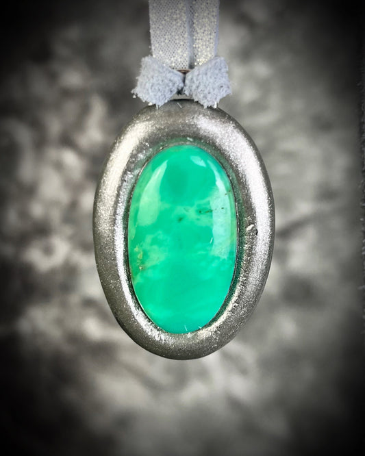 Chrysoprase oval pendant in silver tone setting on silver leather cord. Healing crystal necklace for joy, love, and emotional balance. Handmade mystical jewelry, perfect for layering, meditation, or as a statement gemstone talisman.
