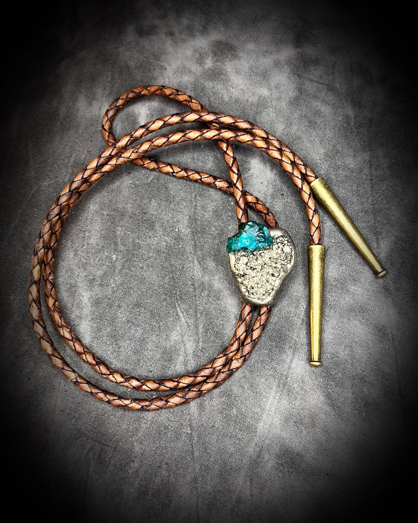 Chunky Pyrite and Dioptase crystal bolo tie on brown leather – unique handmade bolo necklace, artisan gemstone bolo tie jewelry, mystical men’s bolo for bold style.