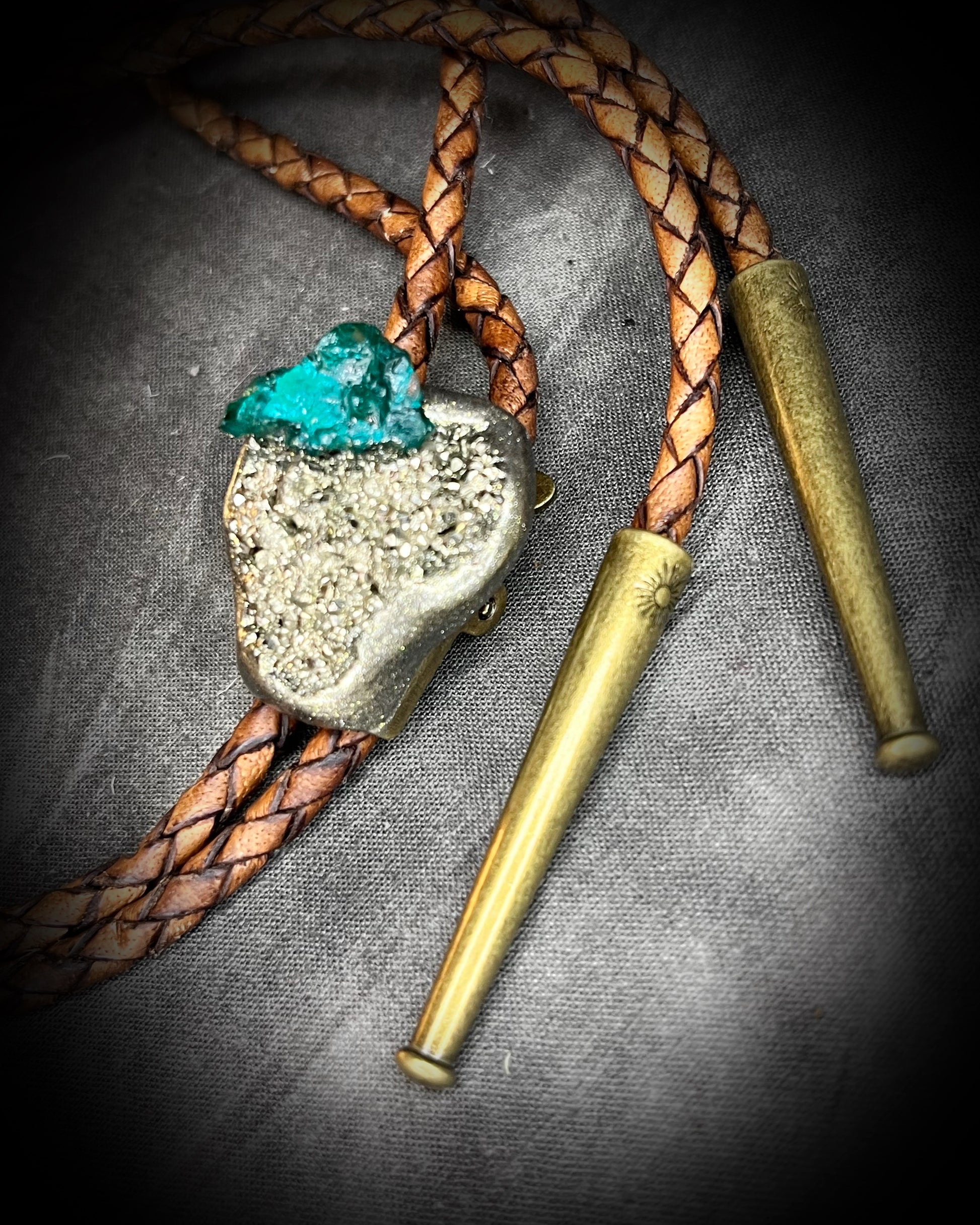 Chunky Pyrite and Dioptase crystal bolo tie on brown leather – unique handmade bolo necklace, artisan gemstone bolo tie jewelry, mystical men’s bolo for bold style.