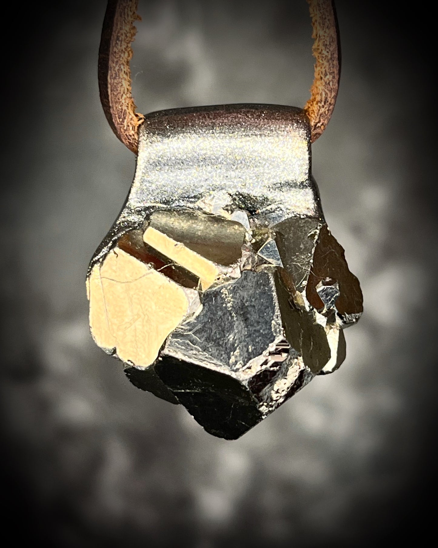 Chunky Pyrite crystal necklace handmade and hung from brown leather. Sculpttural raw gemstone jewelry for her. Manifestation pendant, wearable magic. 