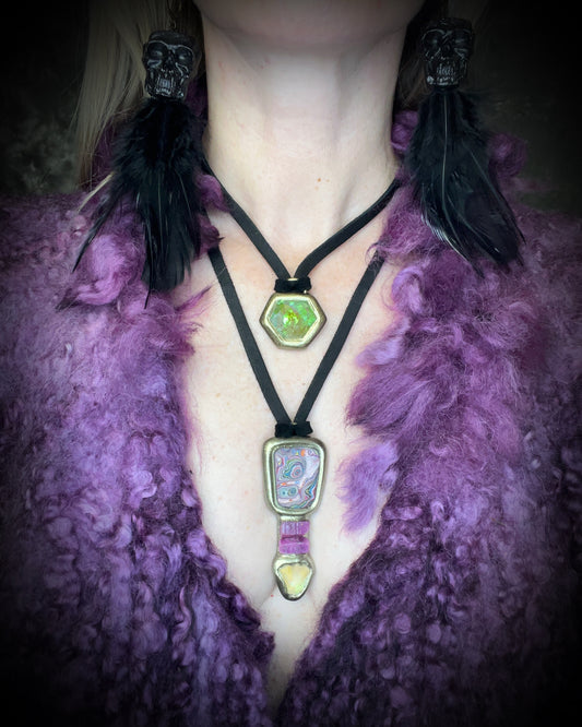 Citrine quartz pyramid crystal with a mystical green glow in a sculptural gold-finish talisman setting on black leather, handmade by Become Spellbound in Baltimore, Maryland.