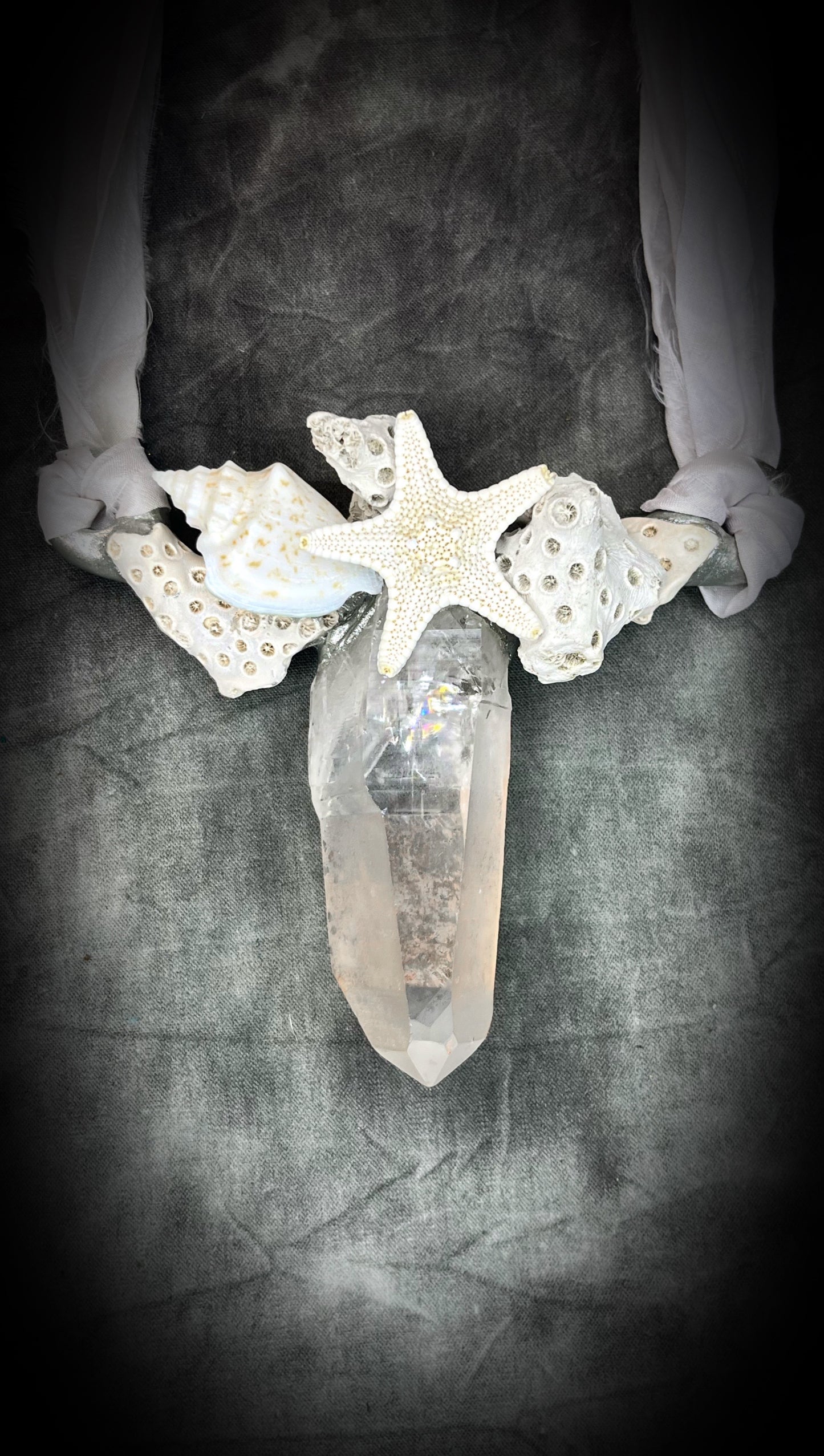 See the rainbows in the gemstone, 
handmade designer bridal or beach bride necklace featuring quartz crystal, white fossilized coral, starfish, seashell and is strung from recycled white silk for an eco-friendly summer beach wedding elegance.  