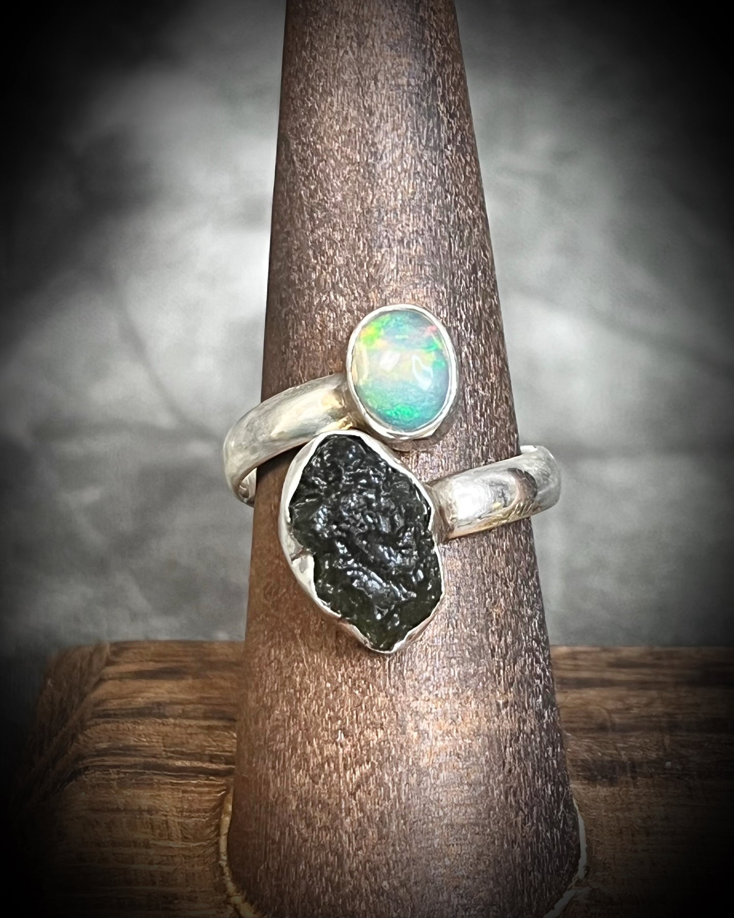 Raw stone adjustable statement rings in sterling silver featuring moldavite crystal and opal gemstone for spiritual elevation and crystal healing. 