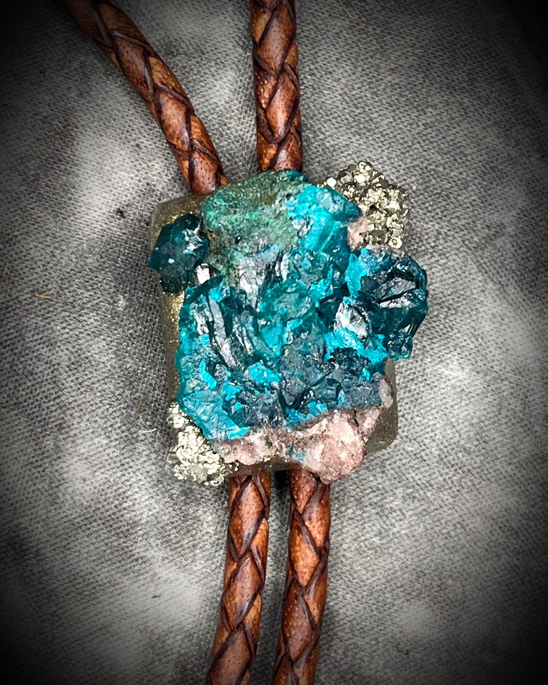 Dioptase and Pyrite bolo tie on brown leather – unique handmade bolo necklace, artisan gemstone bolo tie jewelry, mystical men’s bolo for bold style.