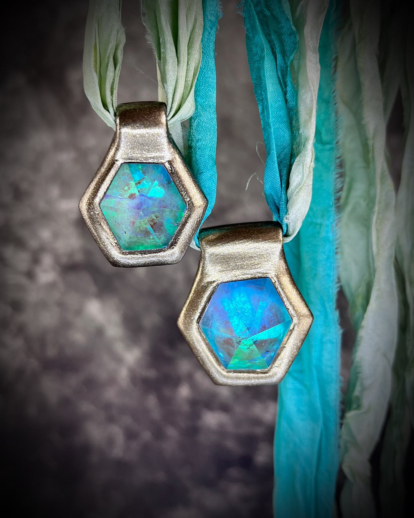 Handmade designer aqua turquoise opalescent quartz gemstone pendants in a gold finish.  These crystal healing necklaces are customizable and can be strung from leather or sea green recycled silk for the sustainable and eco-friendly jewelry lover or mermaid.