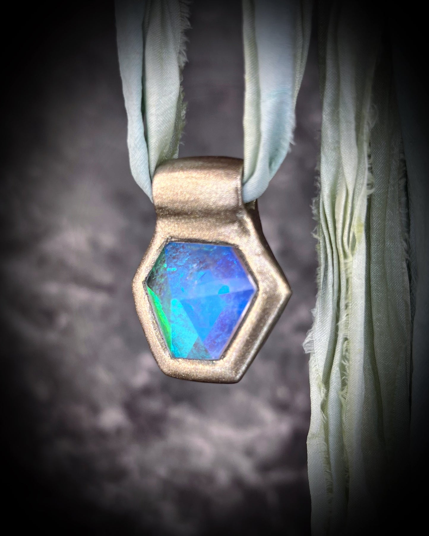 Handmade designer aqua turquoise opalescent quartz gemstone pendants in a gold and silver finish.  These crystal healing necklaces are personalized jewelry and are customizable on leather or recycled silk for the sustainable and eco-friendly jewelry lover or mermaid.