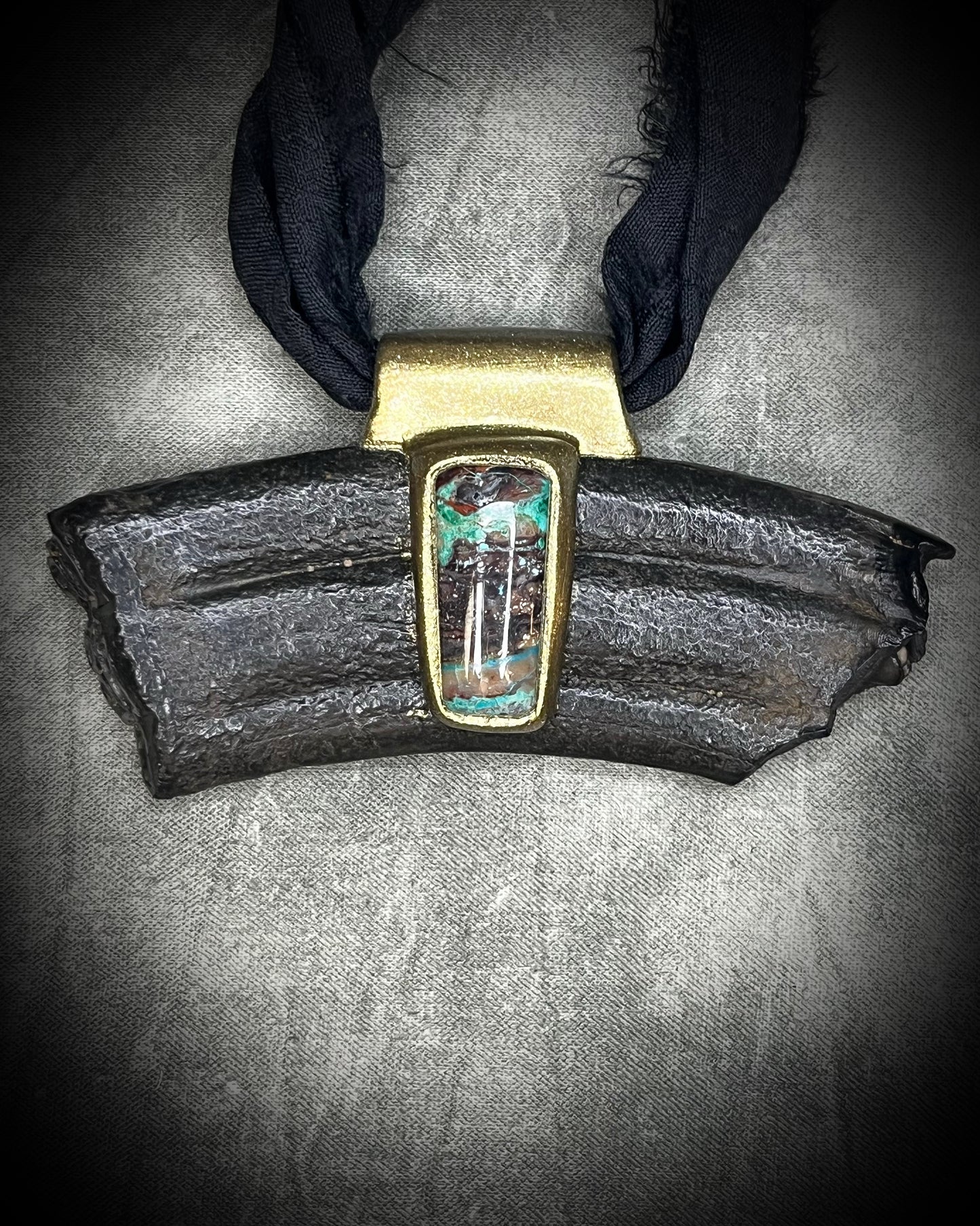 Equus fossil and hand-cut chrysocolla cabochon talisman on black recycled silk, handmade by Kari Dern of Become Spellbound in Baltimore, Maryland.