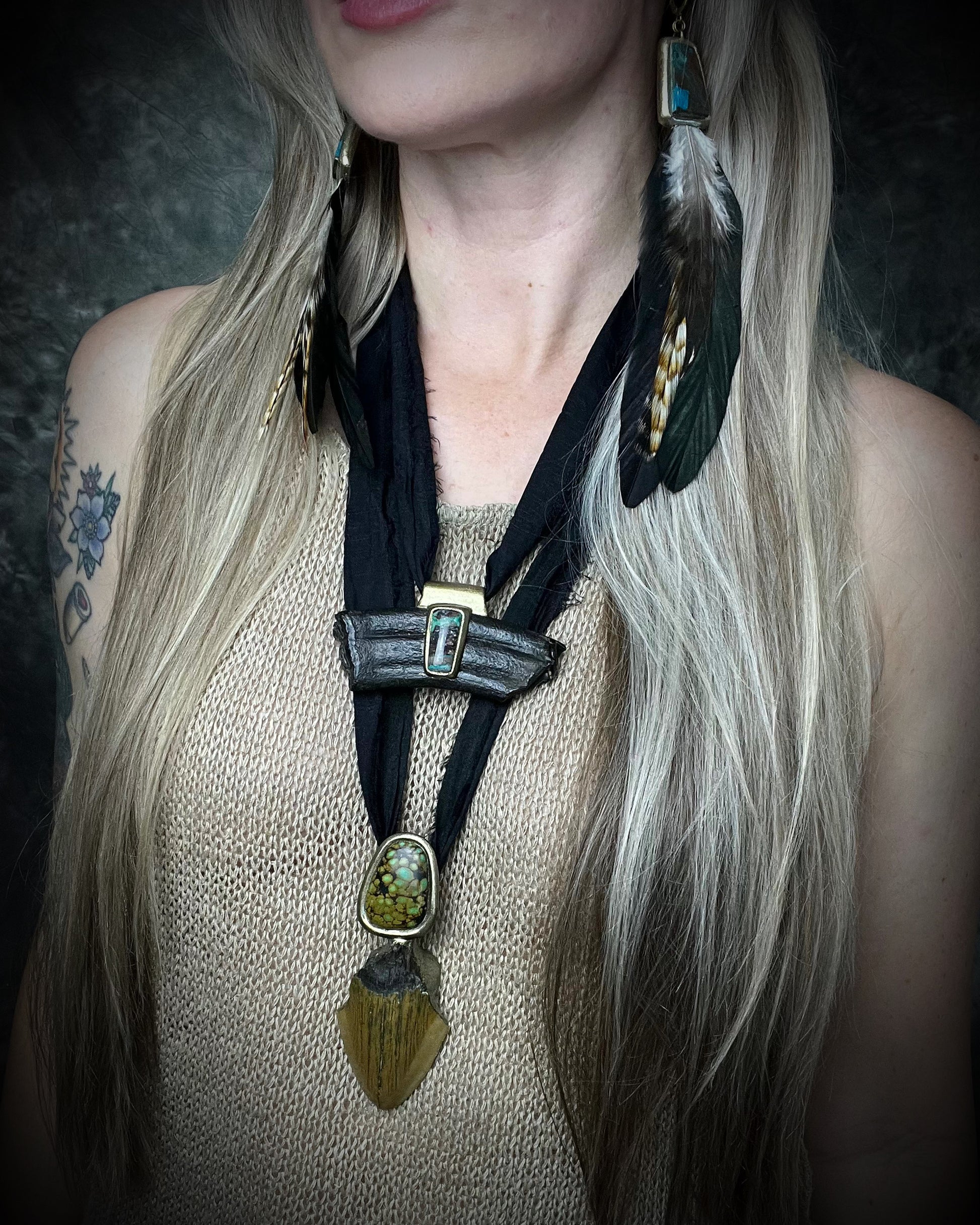 Equus fossil and hand-cut chrysocolla cabochon talisman on black recycled silk, handmade by Kari Dern of Become Spellbound in Baltimore, Maryland. Worn here with feather dangle earrings. 