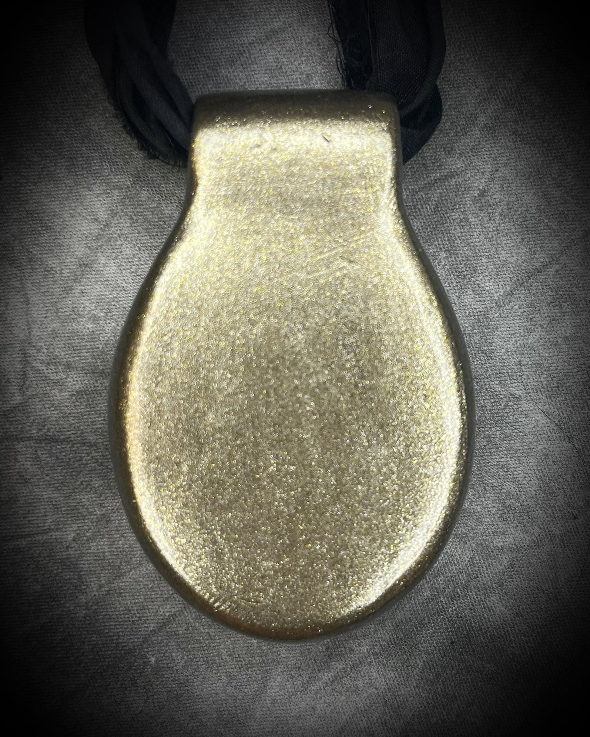 Extra large tiger's eye crystal talisman with golden-brown natural banding, gold finish, and black recycled silk ties, handmade by Become Spellbound in Baltimore, Maryland.