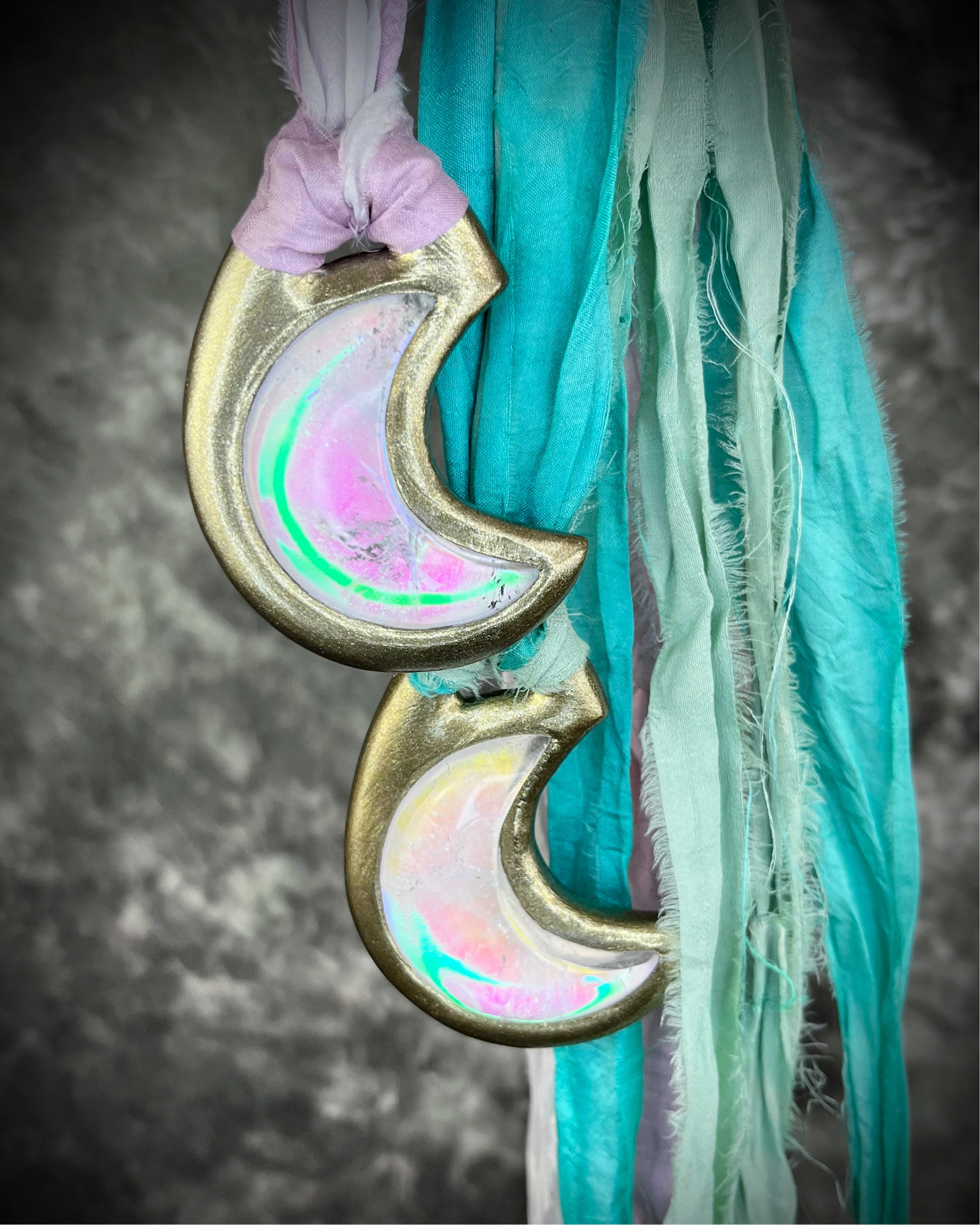 Handmade designer pink and green opalescent quartz gemstone crescent moon pendants in a gold finish.  These crystal healing necklaces are strung from lilac, white, turquoise and mint green recycled silk for the sustainable bride or jewelry collector.
