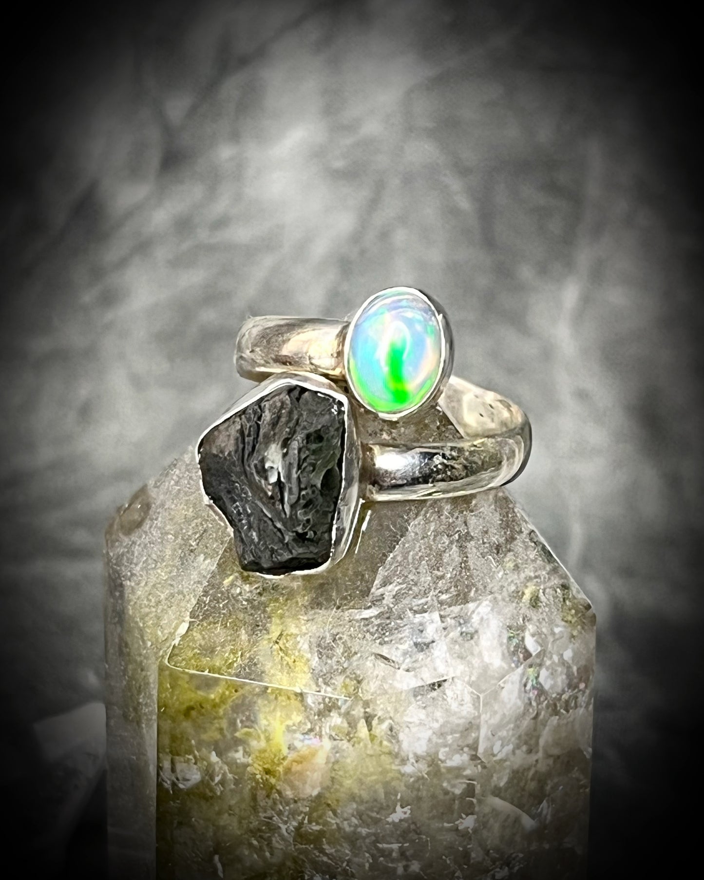 Raw stone adjustable statement rings in sterling silver featuring moldavite crystal and opal gemstone for spiritual elevation and crystal healing. 