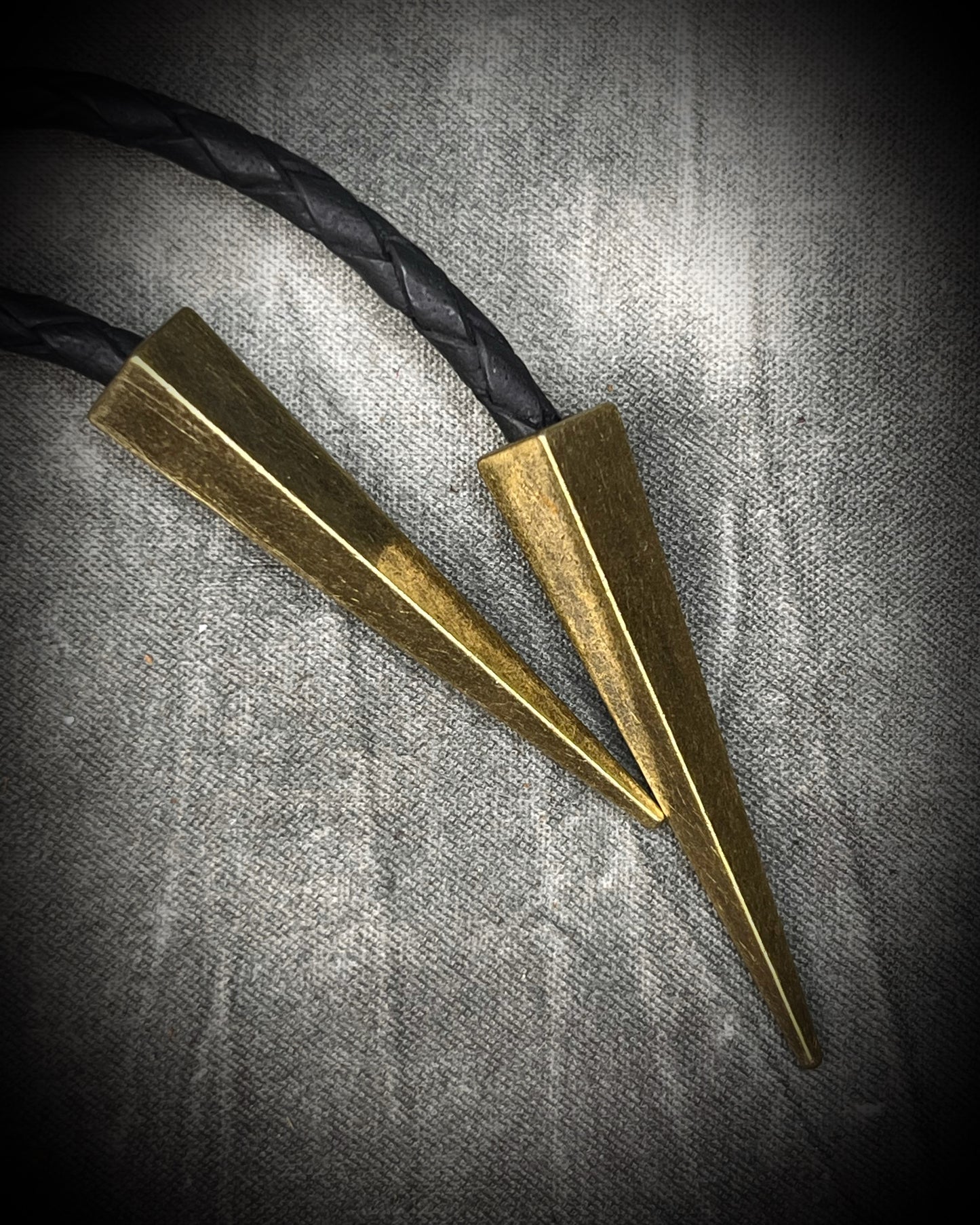 Faceted turquoise blue labradorite bolo tie with black braided leather and gold finish and brass spike tips. Statement Bolo Tie with Labradorite, Western and Witchy Bolo Tie Talisman.