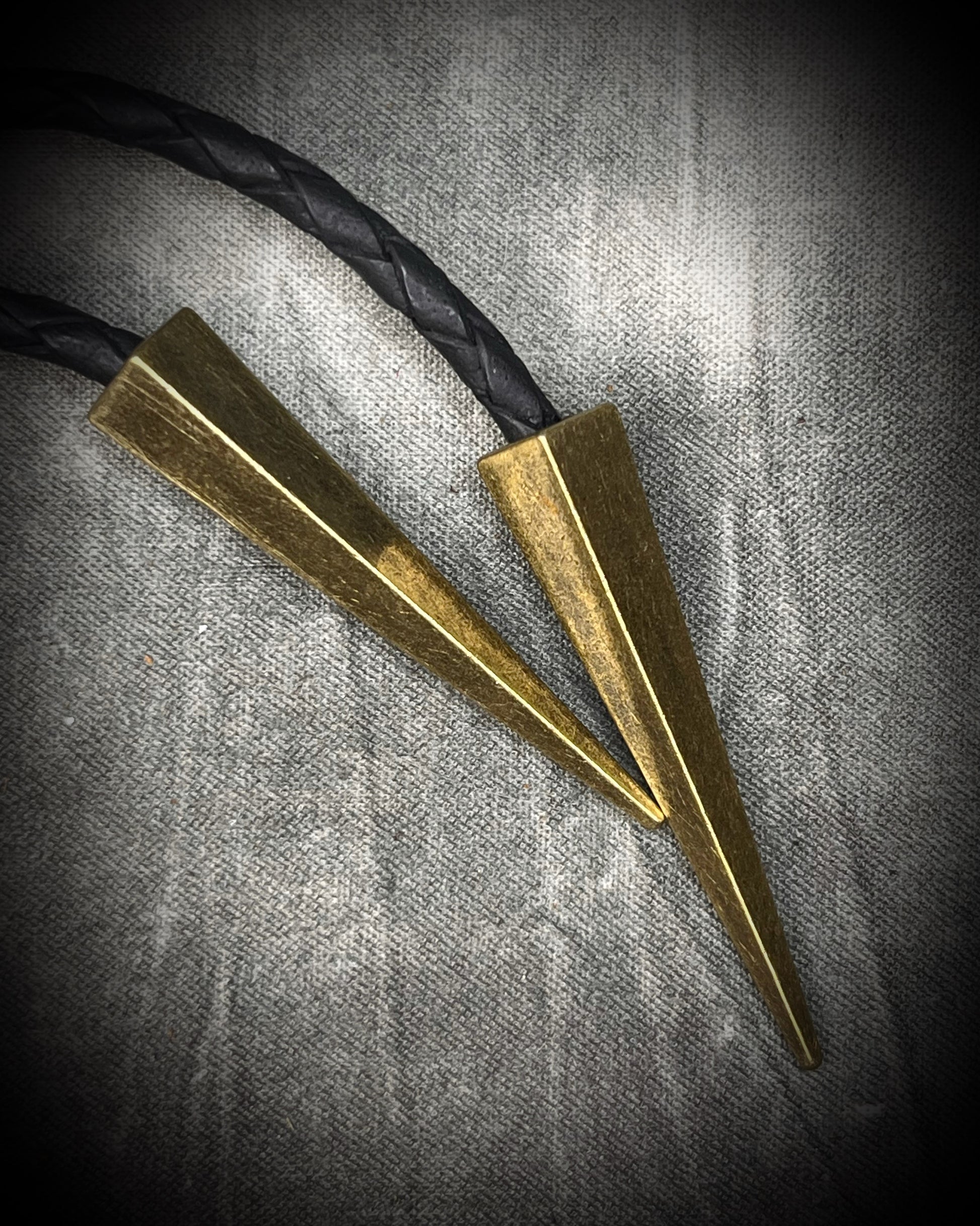 Faceted turquoise blue labradorite bolo tie with black braided leather and gold finish and brass spike tips. Statement Bolo Tie with Labradorite, Western and Witchy Bolo Tie Talisman.