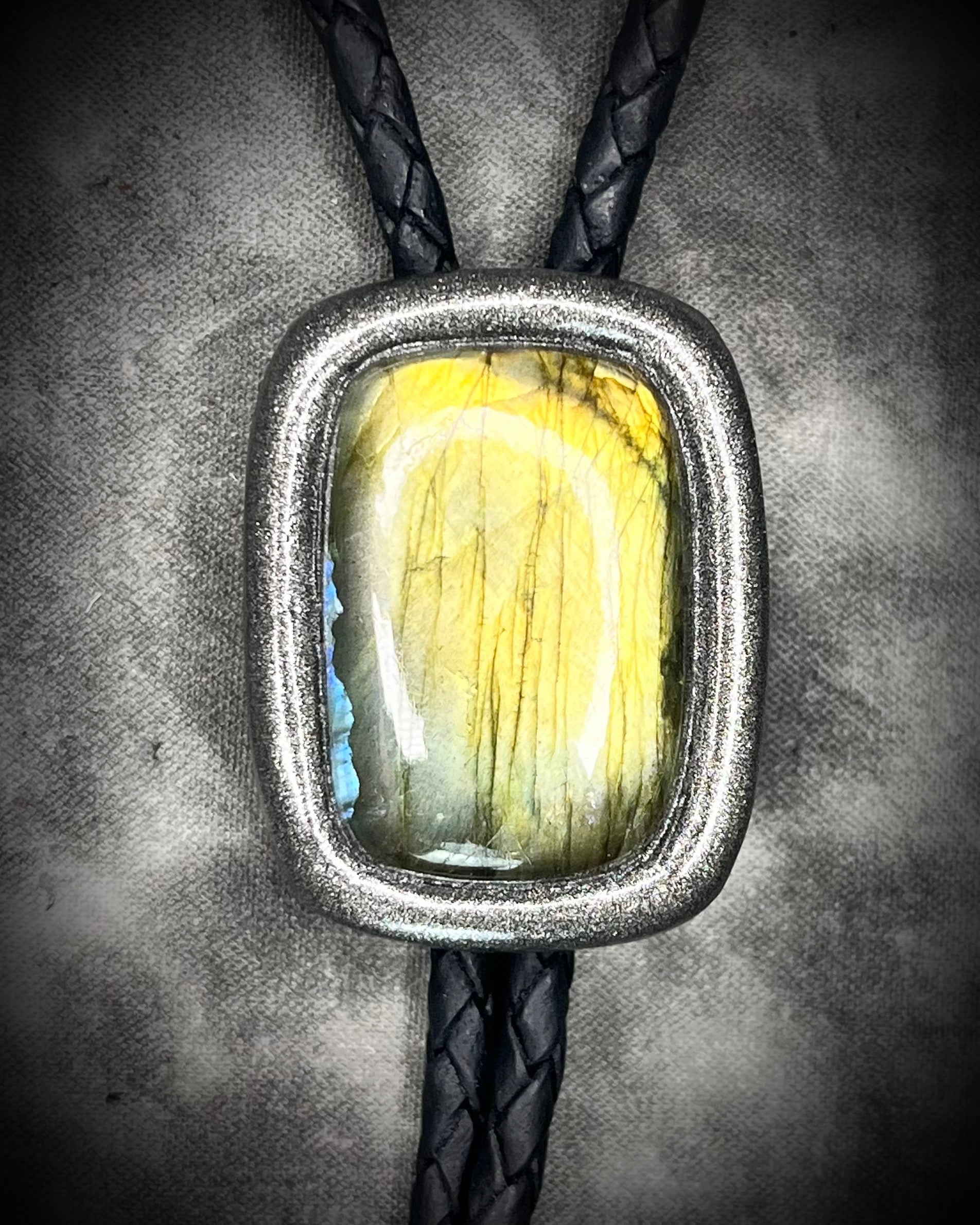 Labradorite Crystal bolo tie jewelry. Trending men’s accessories fall 2025. Statement bolo tie with gemstones. Alternative men’s fashion jewelry. Gender-fluid bolo tie styling. Western-inspired necklace with crystals. Unique leather bolo tie for him or her.