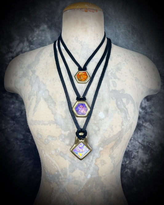 Fire Citrine and Opalescent amethyst hexagon necklaces layered with a glowing quartz pyramid necklace, all hung from black leather on a model bust and sparkling with crystal magic.