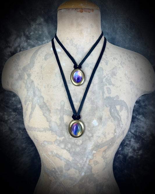 Fluorite cabochon oval necklaces in gold tone settings on black leather worn as layering necklaces on a bust– mystical crystal jewelry for clarity, focus, and balance. Handmade gemstone pendant talismans, grounding and protective fluorite statement necklaces, perfect spiritual jewelry for daily wear, meditation, or gifting.