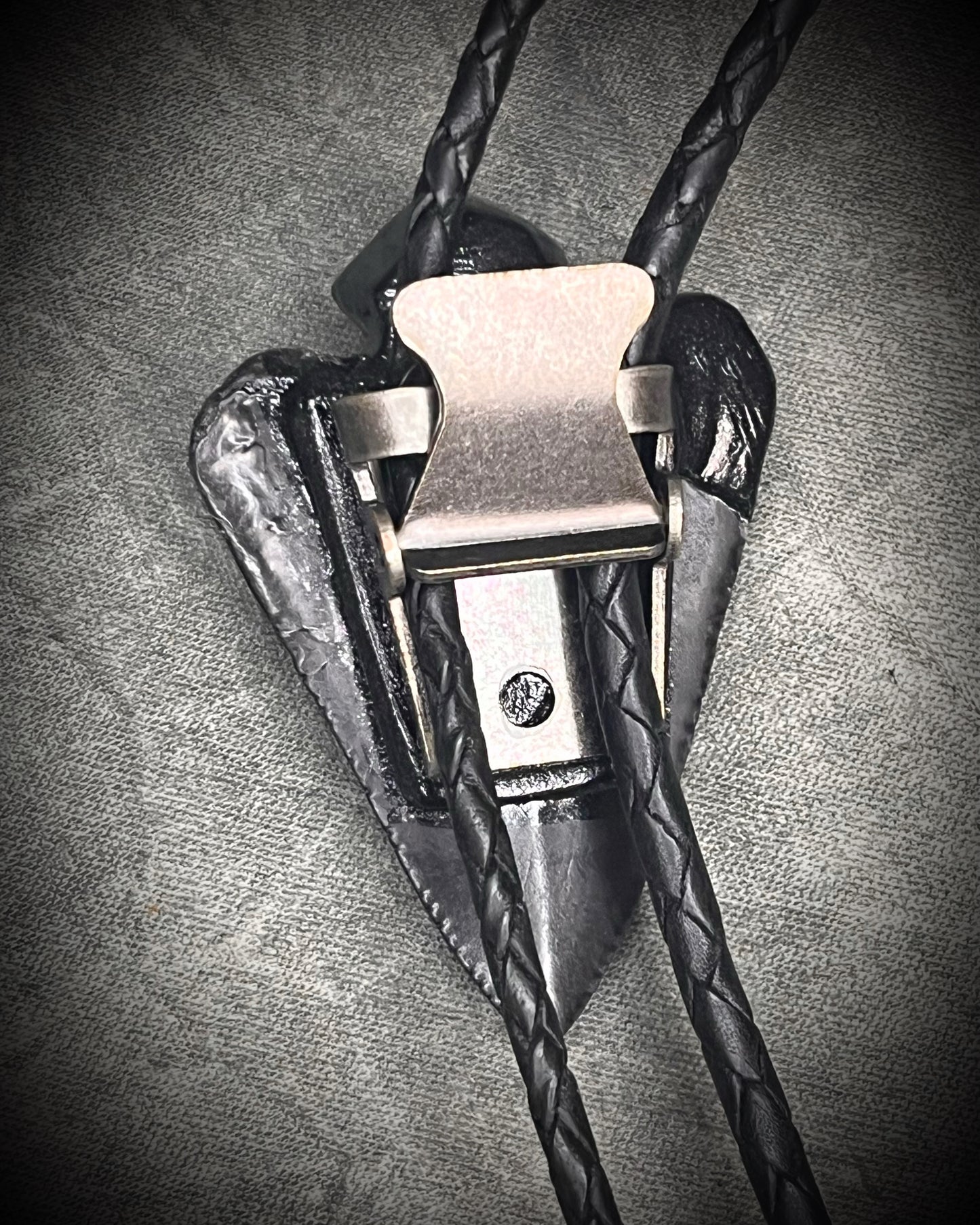 Fossil Great White shark tooth bolo tie with petroleum quartz crystal, black leather, and black spike tips, gothic statement fossil jewelry handmade in Baltimore Maryland. Back clasp view.