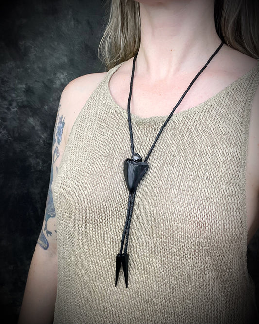 Fossil Great White shark tooth bolo tie with petroleum quartz crystal, black leather, and black spike tips, gothic statement fossil jewelry handmade in Baltimore Maryland