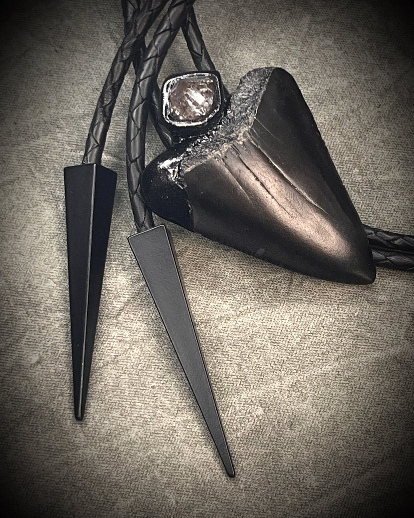 Fossil Great White shark tooth bolo tie with petroleum quartz crystal, black leather, and black spike tips, gothic statement fossil jewelry handmade in Baltimore Maryland