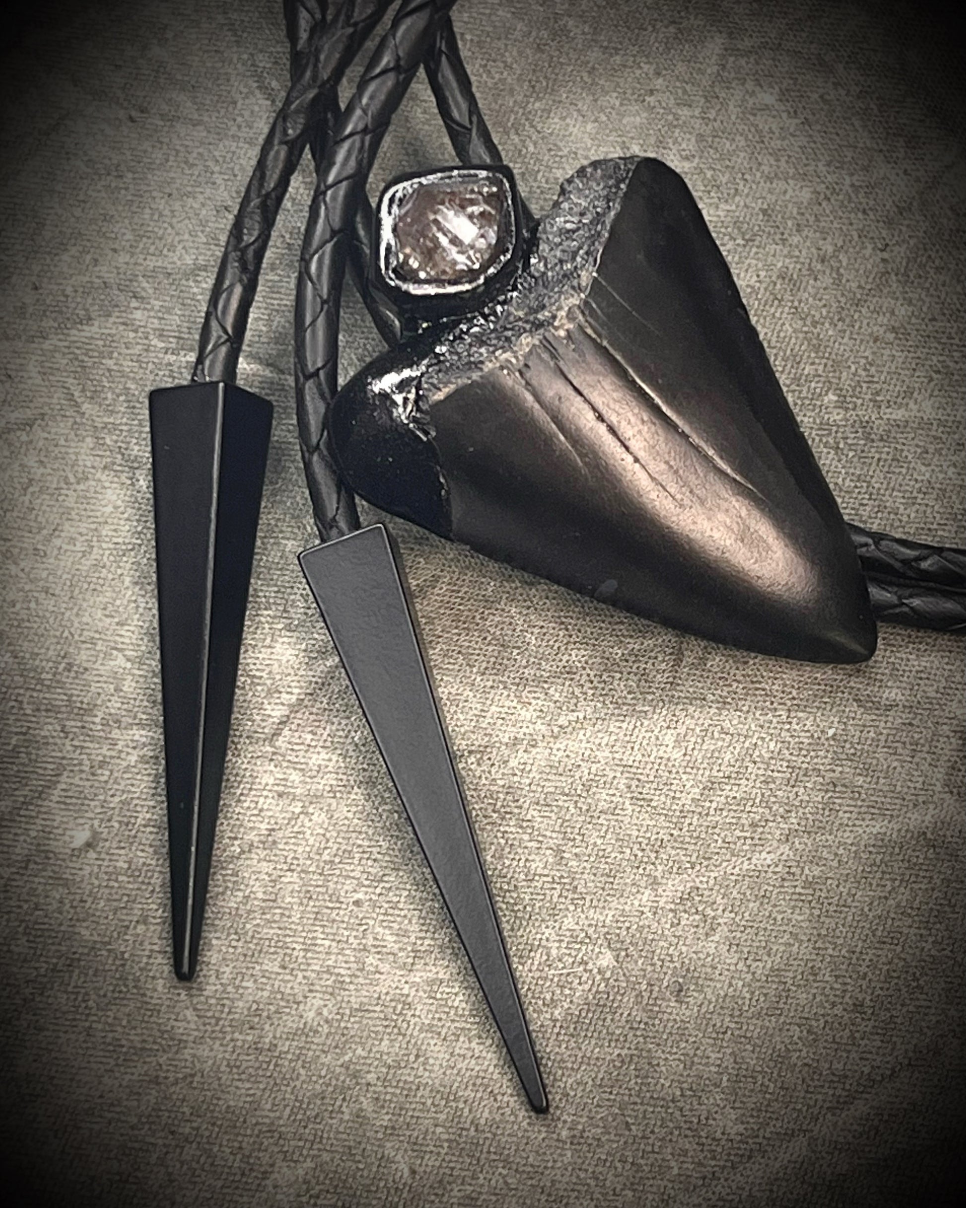 Fossil Great White shark tooth bolo tie with petroleum quartz crystal, black leather, and black spike tips, gothic statement fossil jewelry handmade in Baltimore Maryland