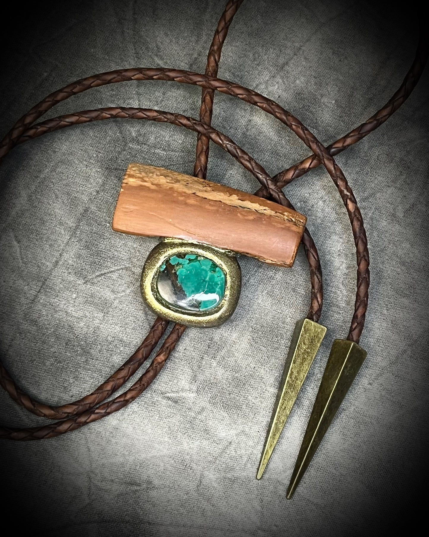 Fossilized mammoth tusk and chrysocolla bolo tie on brown leather with gold finish and gold spike tips, handmade by Become Spellbound.