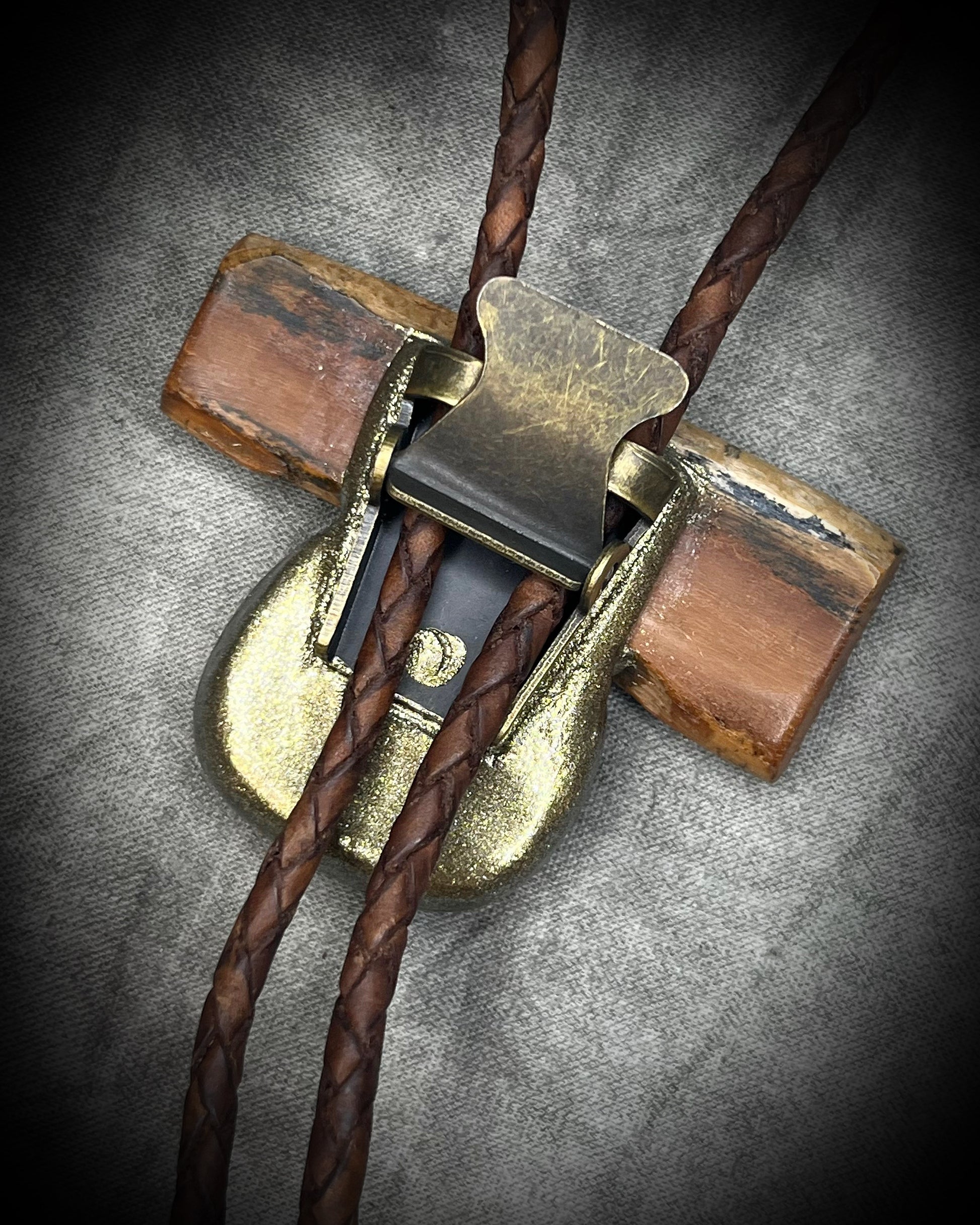 Fossilized mammoth tusk and chrysocolla bolo tie on brown leather with gold finish and gold spike tips, handmade by Become Spellbound.