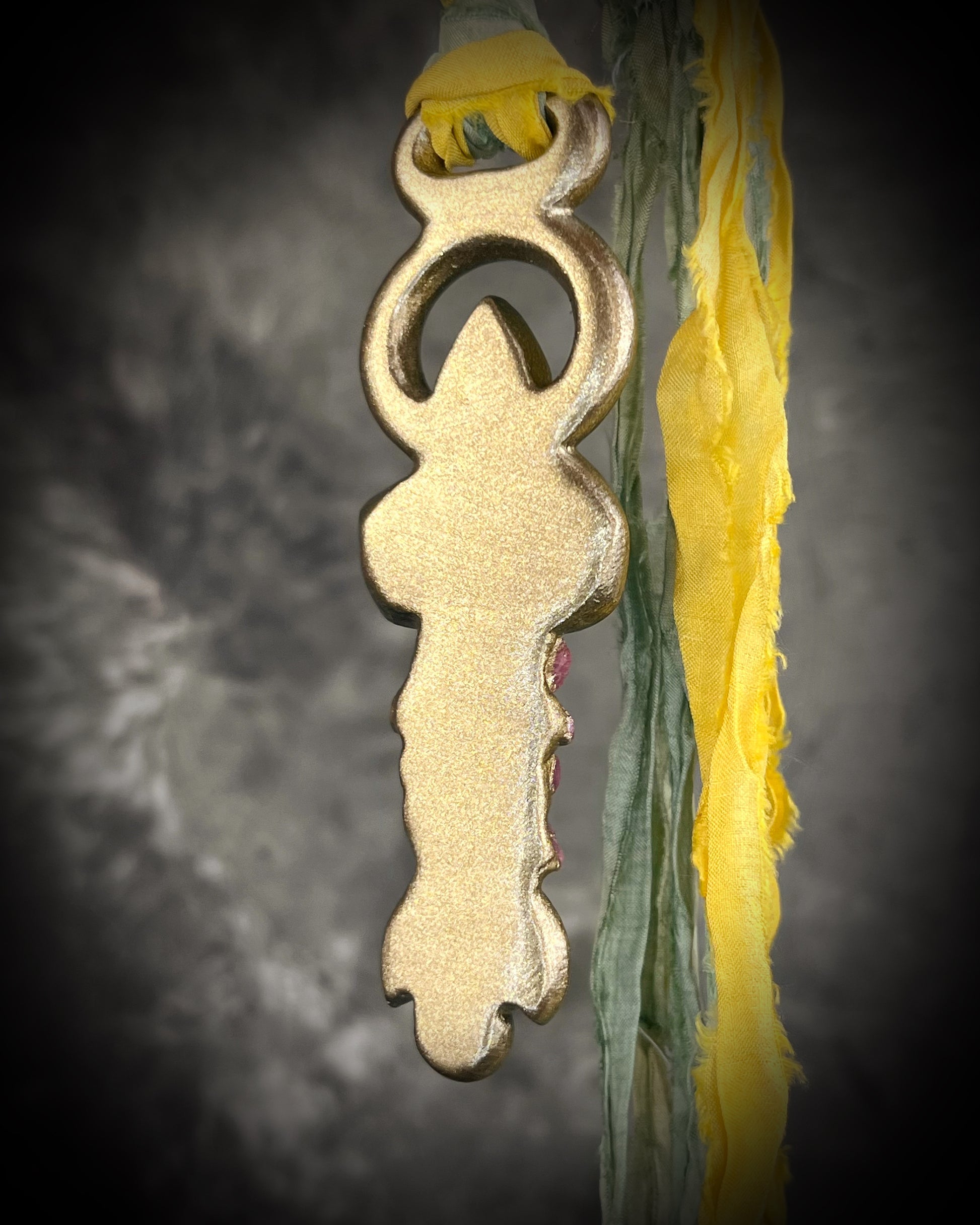 Fully hand sculpted Libyan Desert Glass talisman pendant with raw ruby crystals, prasiolite moon, lepidolite, green tourmaline, and luminous shifting color on recycled silk. Museum grade art jewelry by Become Spellbound.