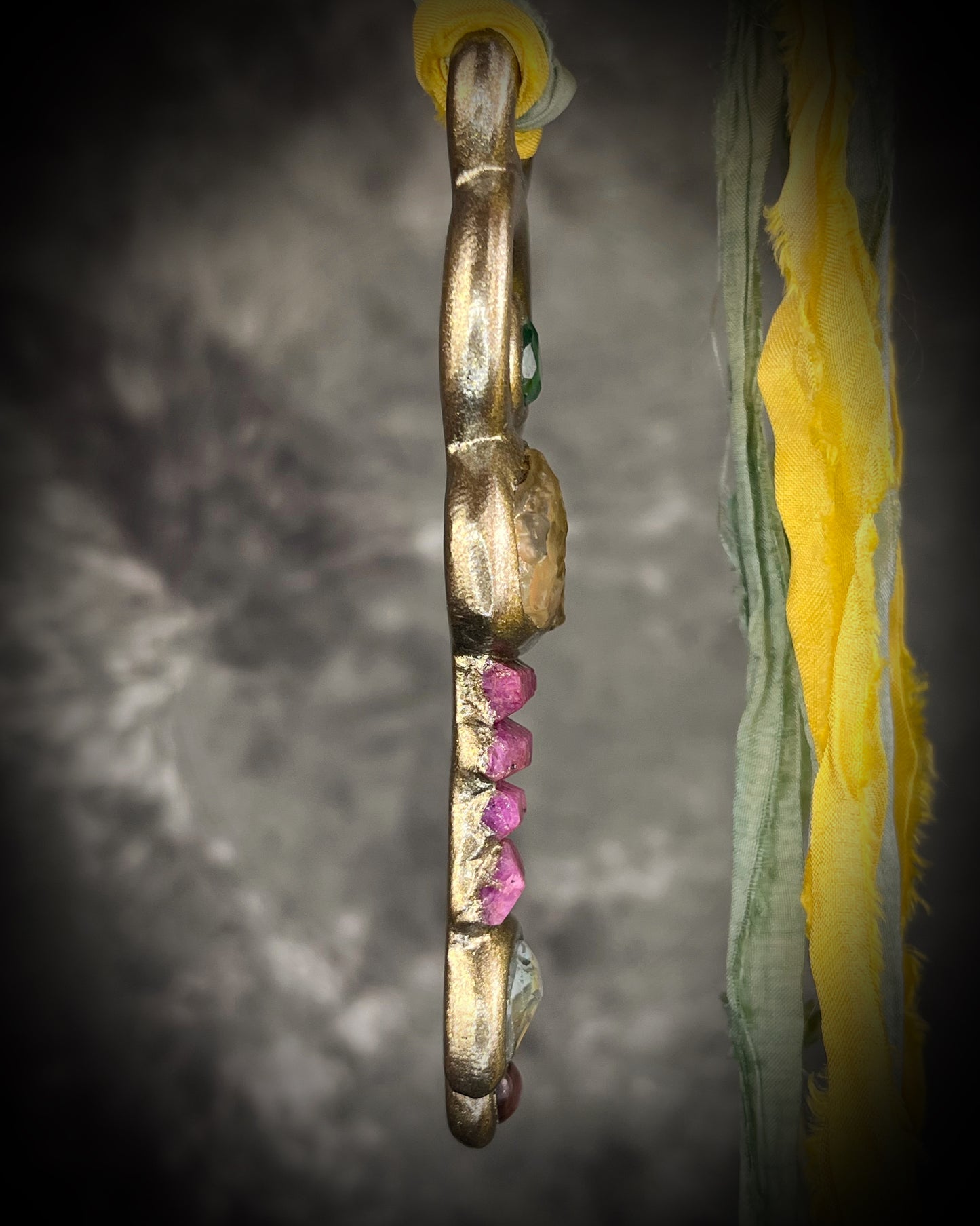 Fully hand sculpted Libyan Desert Glass talisman pendant with raw ruby crystals, prasiolite moon, lepidolite, green tourmaline, and luminous shifting color on recycled silk. Museum grade art jewelry by Become Spellbound.