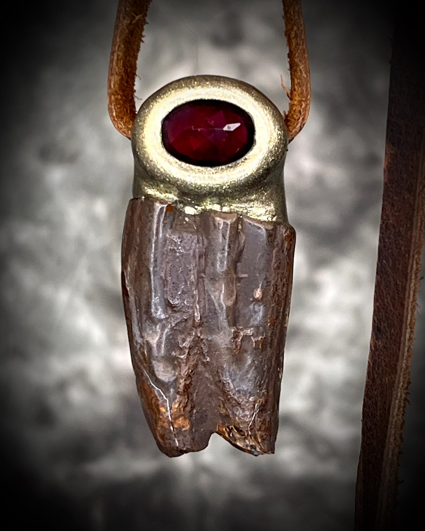 Garnet and Equus fossil tooth talisman necklace in gold finish on brown leather cord, handmade statement fossil jewelry from Baltimore Maryland