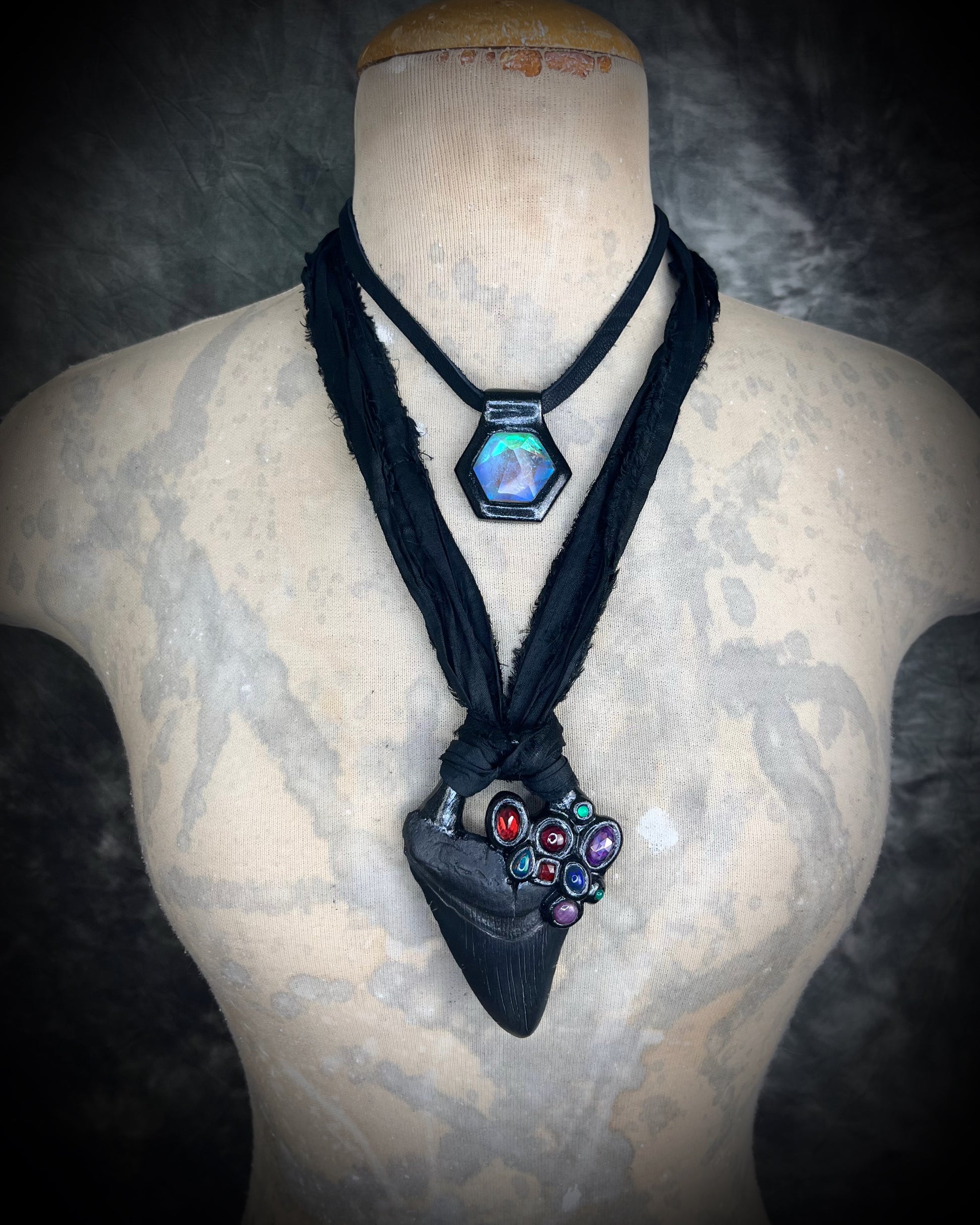 Dark Queen inspired handmade gemstone encrusted megalodon fossil tooth necklace.  This talisman serves to ground and protect and would be at home on a fantasy film set or a birthday cosplay costume!  Made in the USA on recycled silk for eco-friendly dark luxury. 