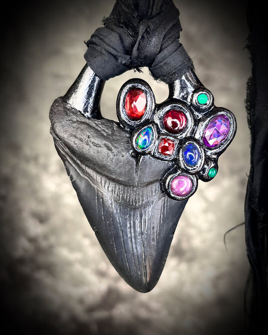 Dark Queen inspired handmade gemstone encrusted megalodon fossil tooth necklace.  This talisman serves to ground and protect and would be at home on a fantasy film set or a birthday cosplay costume!  Made in the USA on recycled silk for eco-friendly dark luxury. 